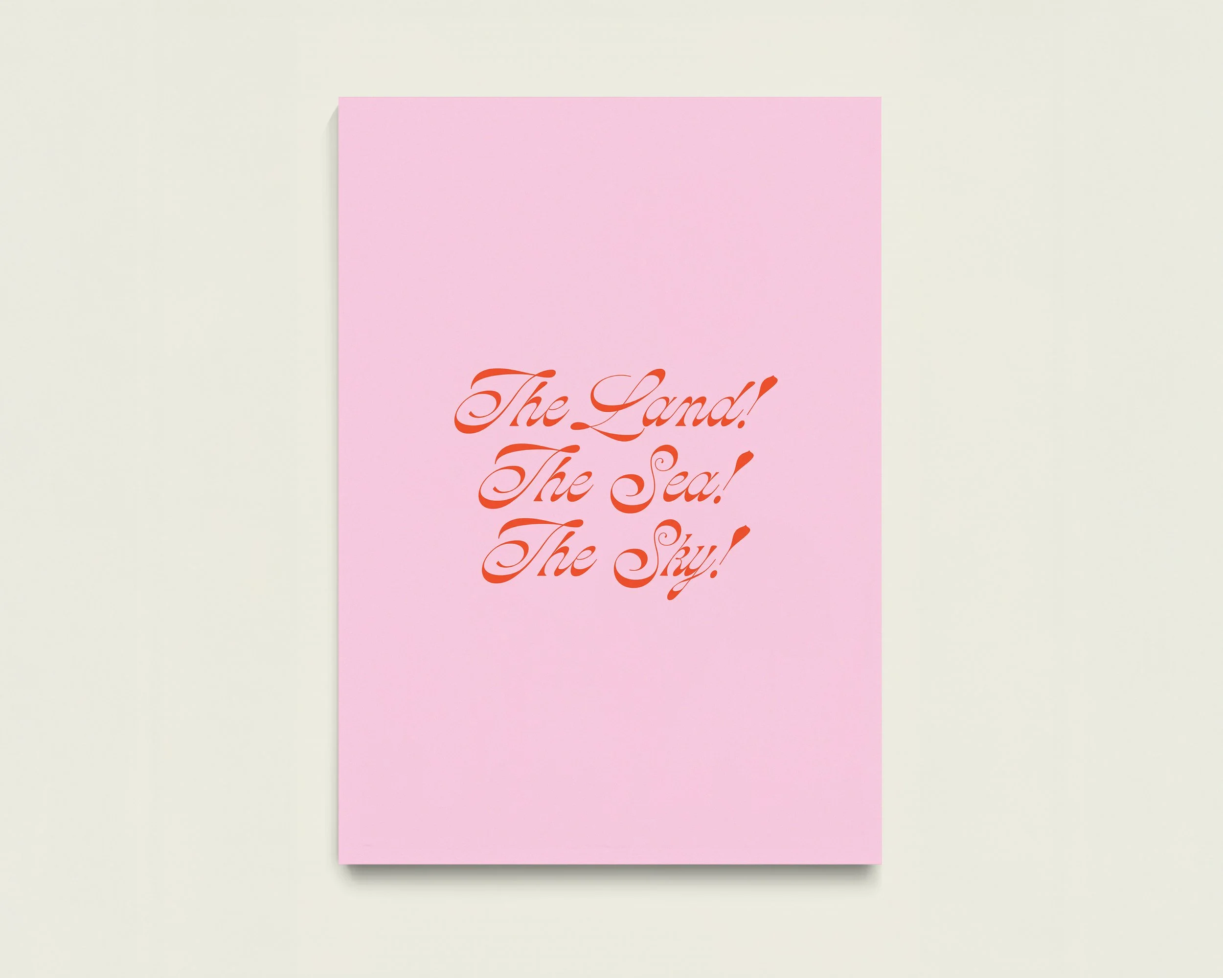 Pink card with red cursive text that reads 'The Land! The Sea! The Sky!'