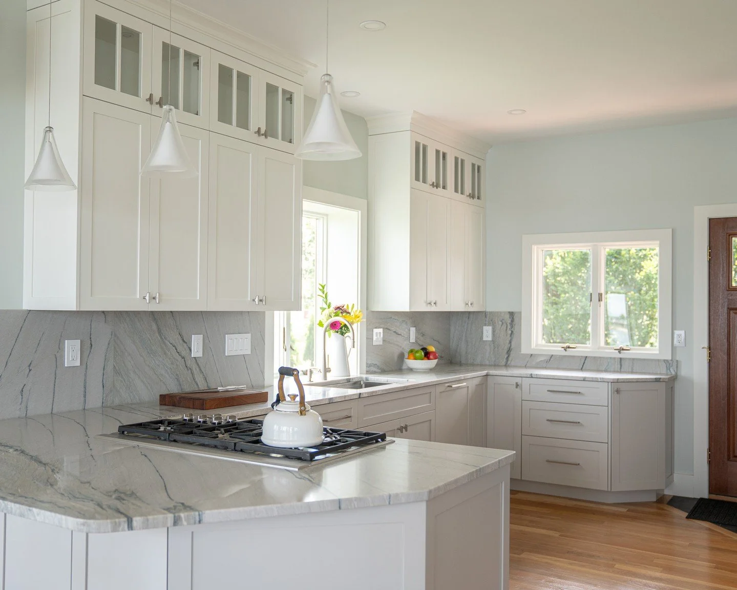 Bright, airy, and timeless&mdash;this kitchen is grounded by stunning natural stone countertops and backsplash that bring subtle movement and elegance into the space. Clean cabinetry and soft light make every corner feel fresh and inviting, creating 