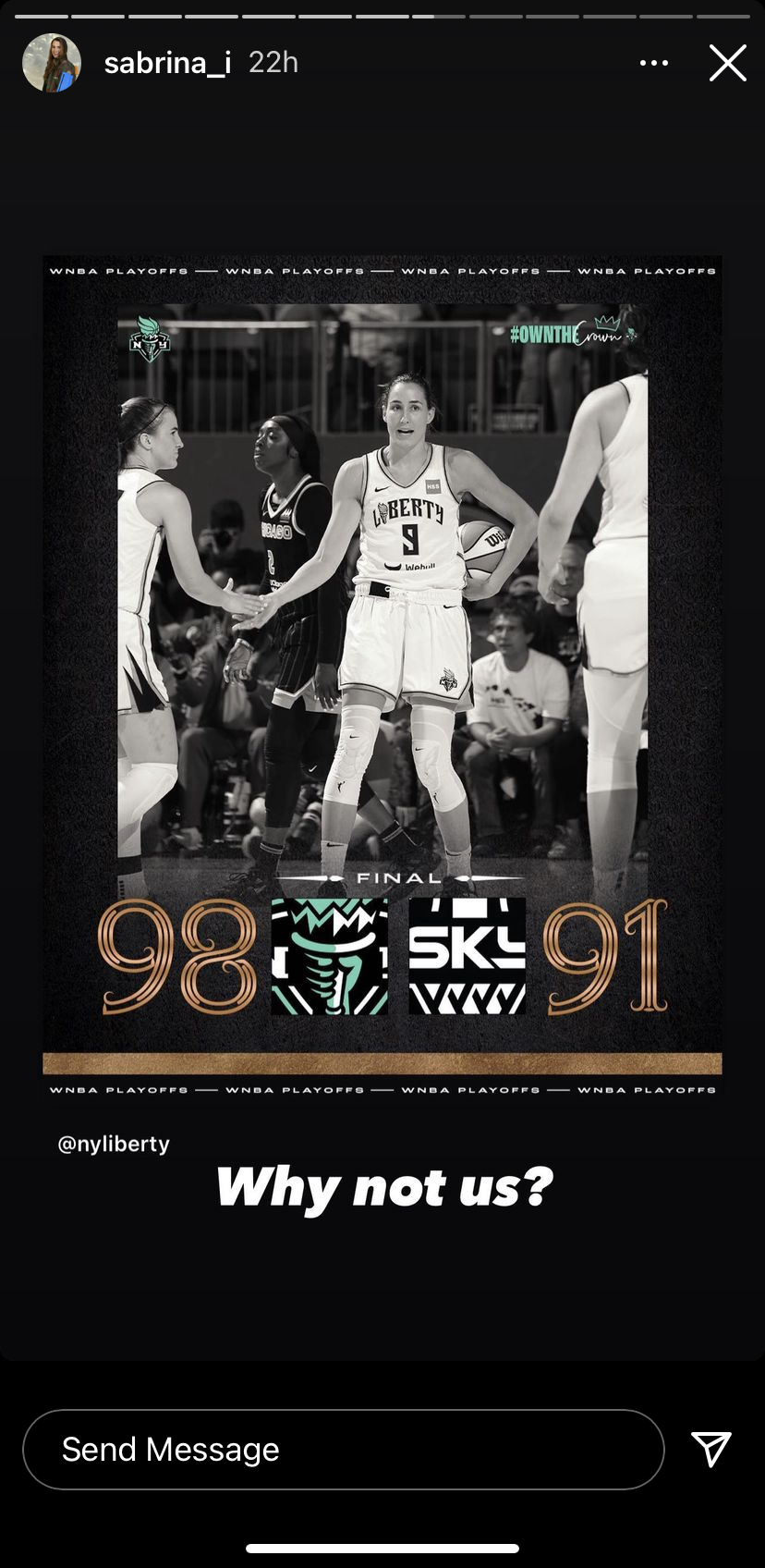 Black and white image of a women's basketball game, showing players from Liberty and Chicago teams. The score is Liberty 98, Chicago 91. A player from Liberty is holding a basketball and shaking hands with a player from Chicago. The background includ