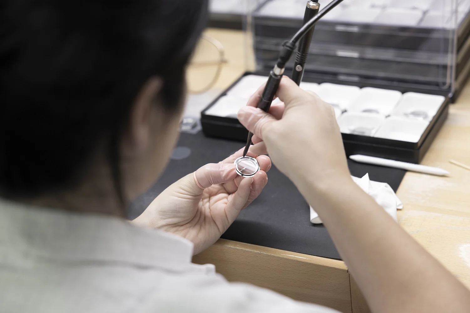 Watchmaker assembling a Swiss watch at the bench in La Chaux-de-Fonds