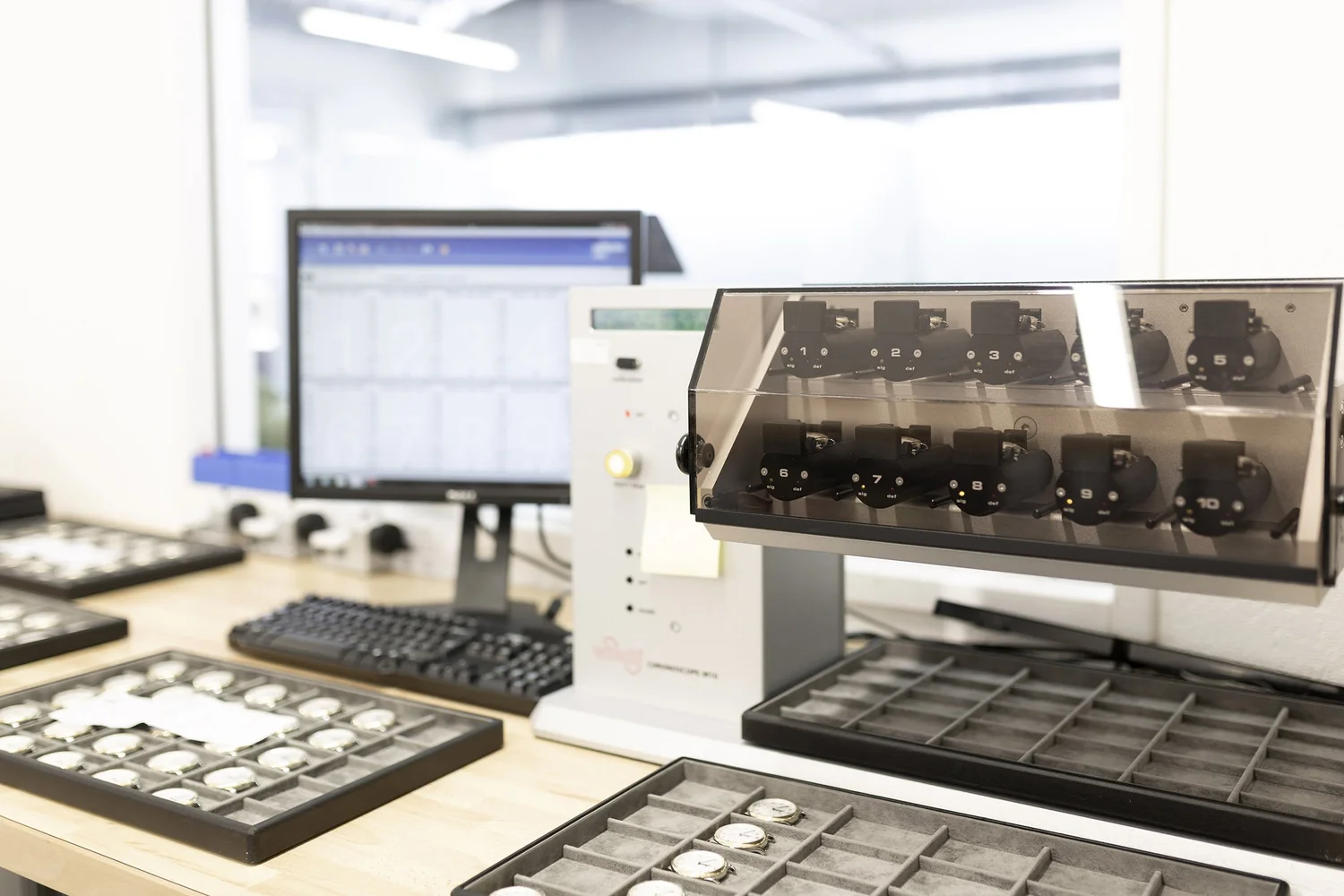 Watch components organised in trays in a Swiss workshop