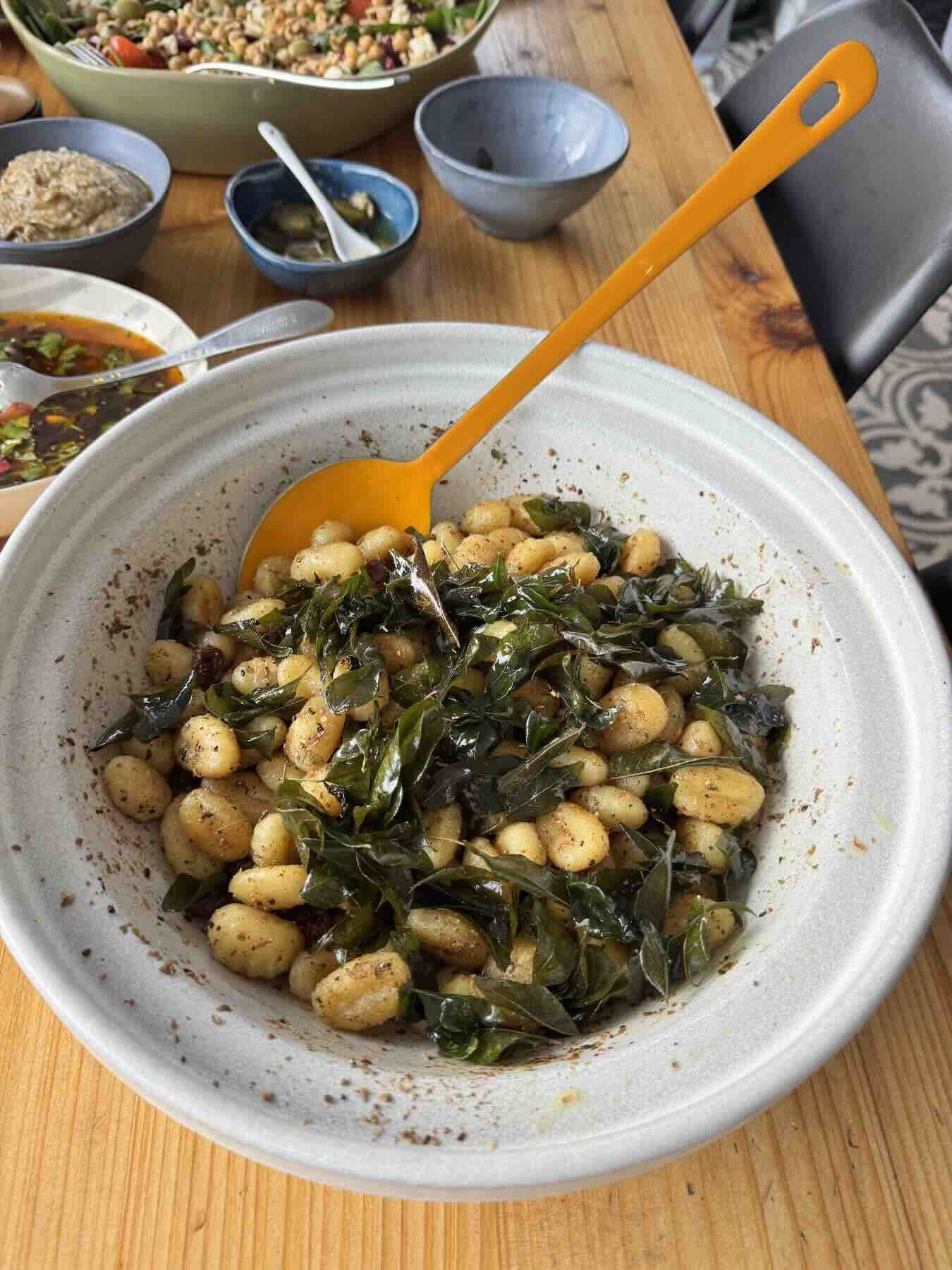 Gnocchi side dish with fried curry leaves and raisins