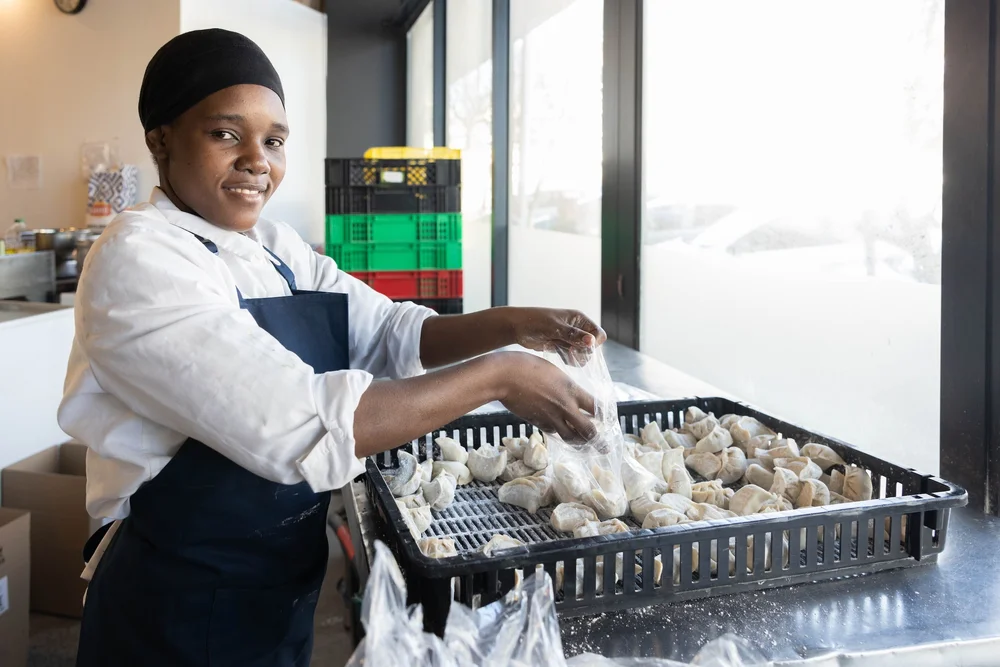 HOME.BAO employee making frozen dumplings and potstickers in the factory in Cape Town 1:2.jpeg