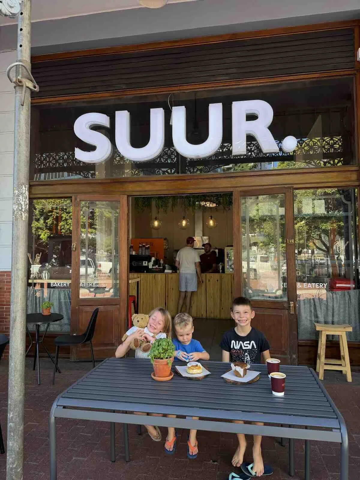 Shawn Godfrey and Francois Zietsman catching up at Suur whilst kids enjoy baked goods.jpeg