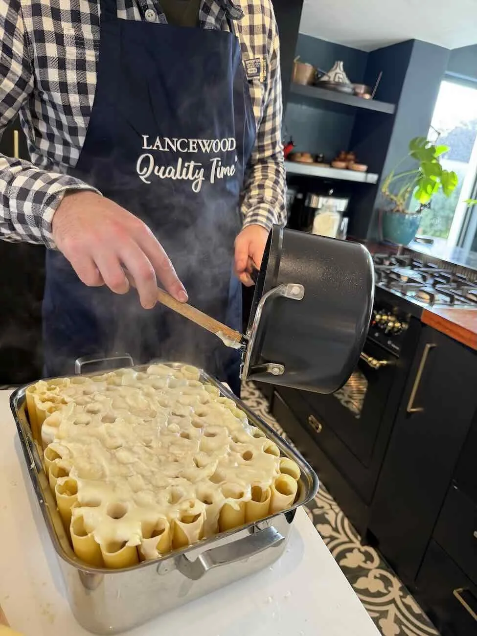 Pouring cheese sauce over Braai blik mac n cheese.jpeg