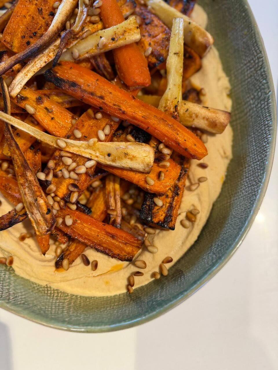 Charred honey-glazed carrots and parsnips with whipped feta hummus
