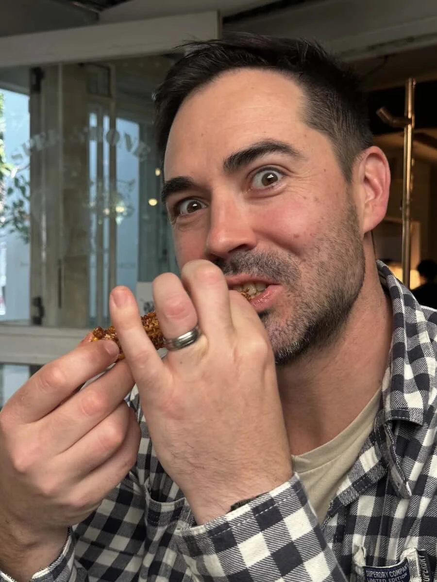 Shawn eating the Atlas Peri-Peri Corn Ribs with Lime Dip