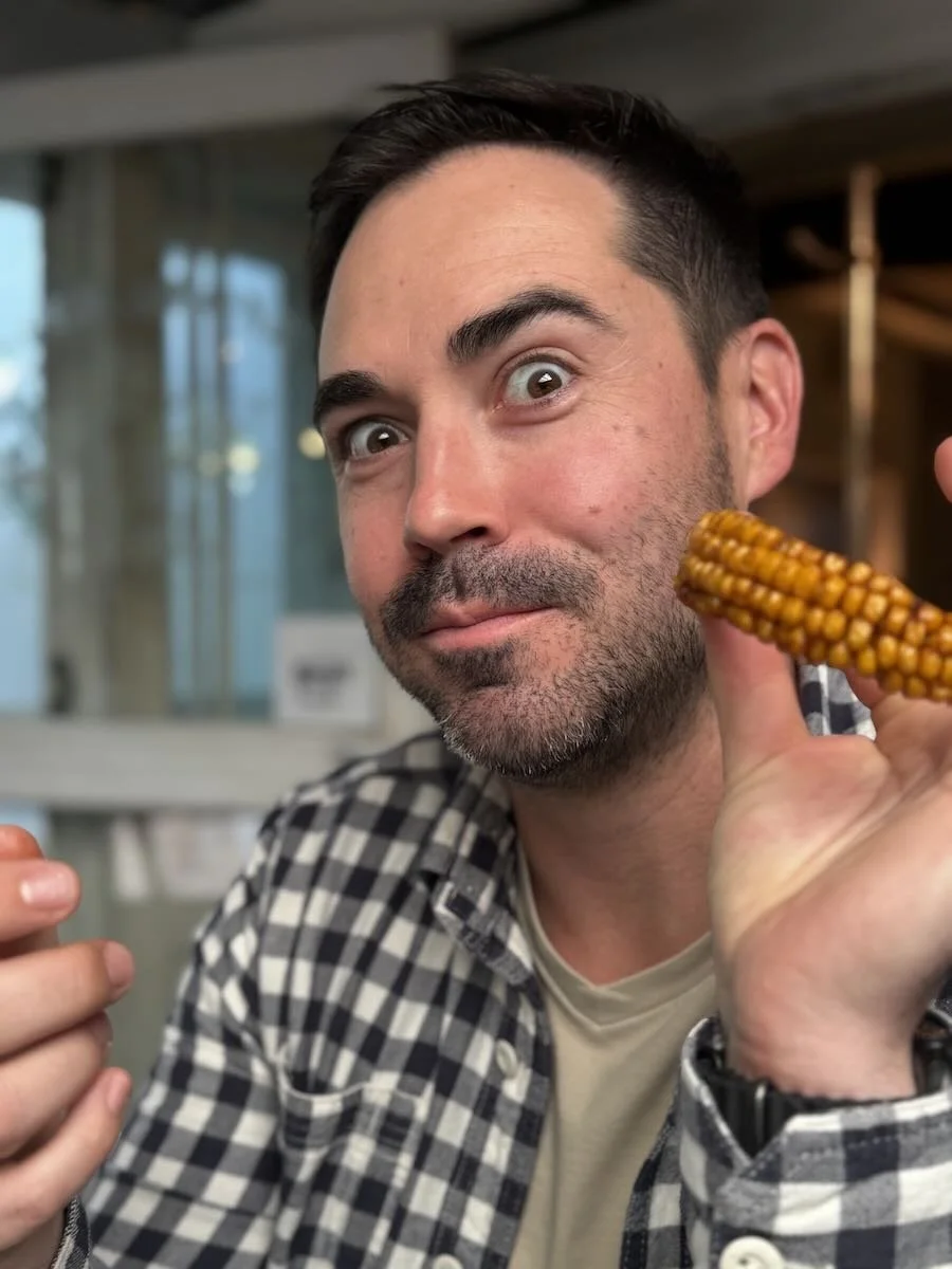 Shawn eating the Atlas Peri-Peri Corn Ribs with Lime Dip