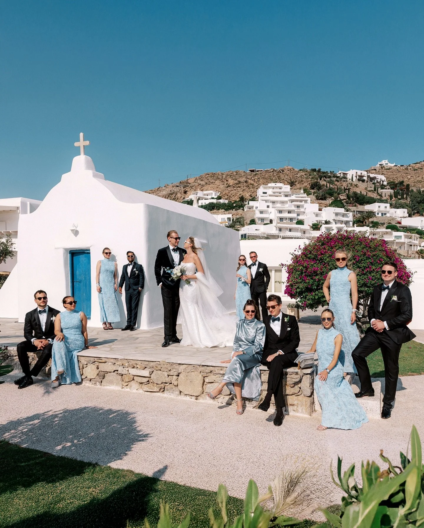 Nikolai &amp; Vanessa, framed in timeless elegance with their bridal party. A Mykonian wedding at iconic @santamarinamykonos