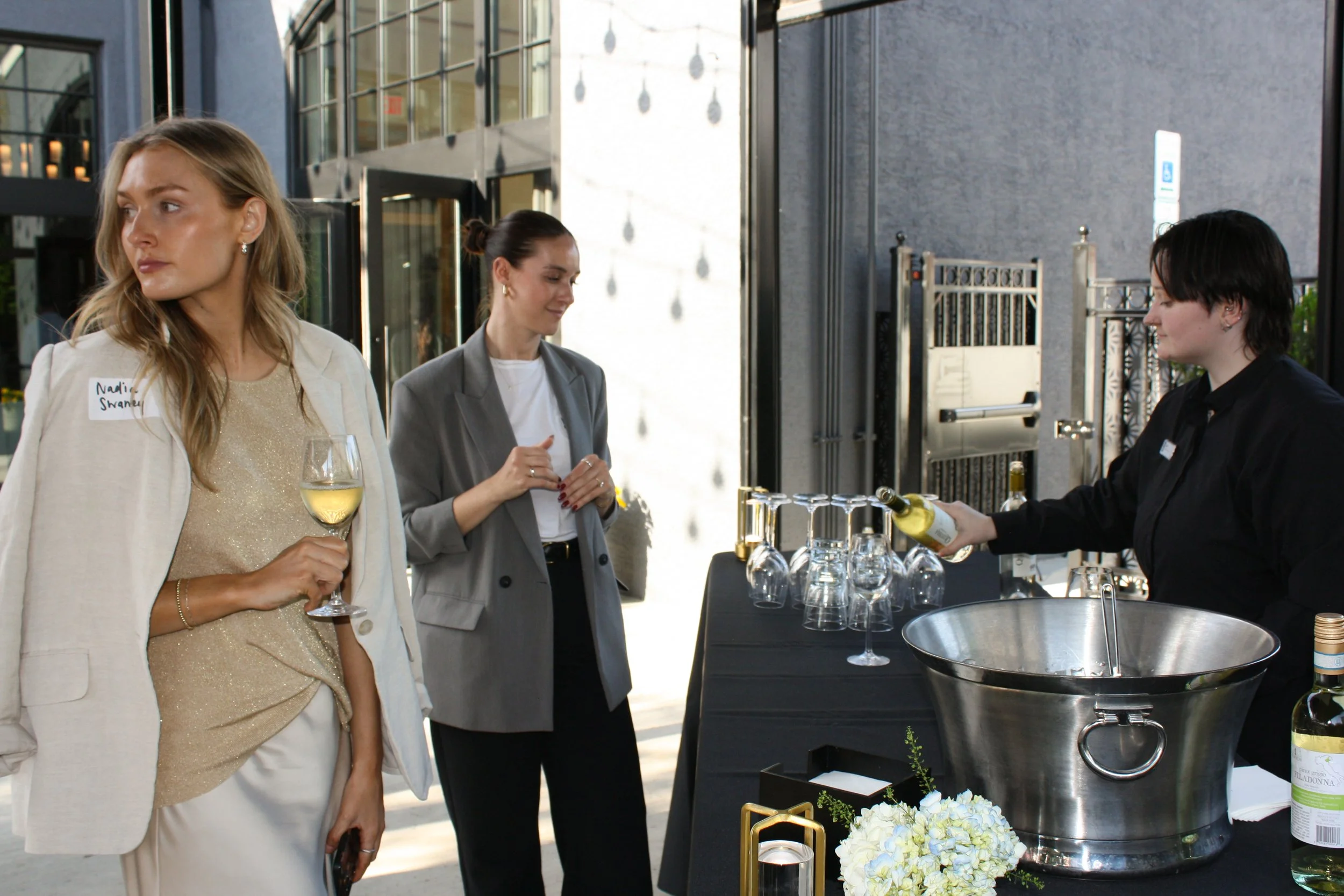 A couple of happy hour guests wait for their drink at the outdoor bar at High Line Car House in downtown Columbus, Ohio.