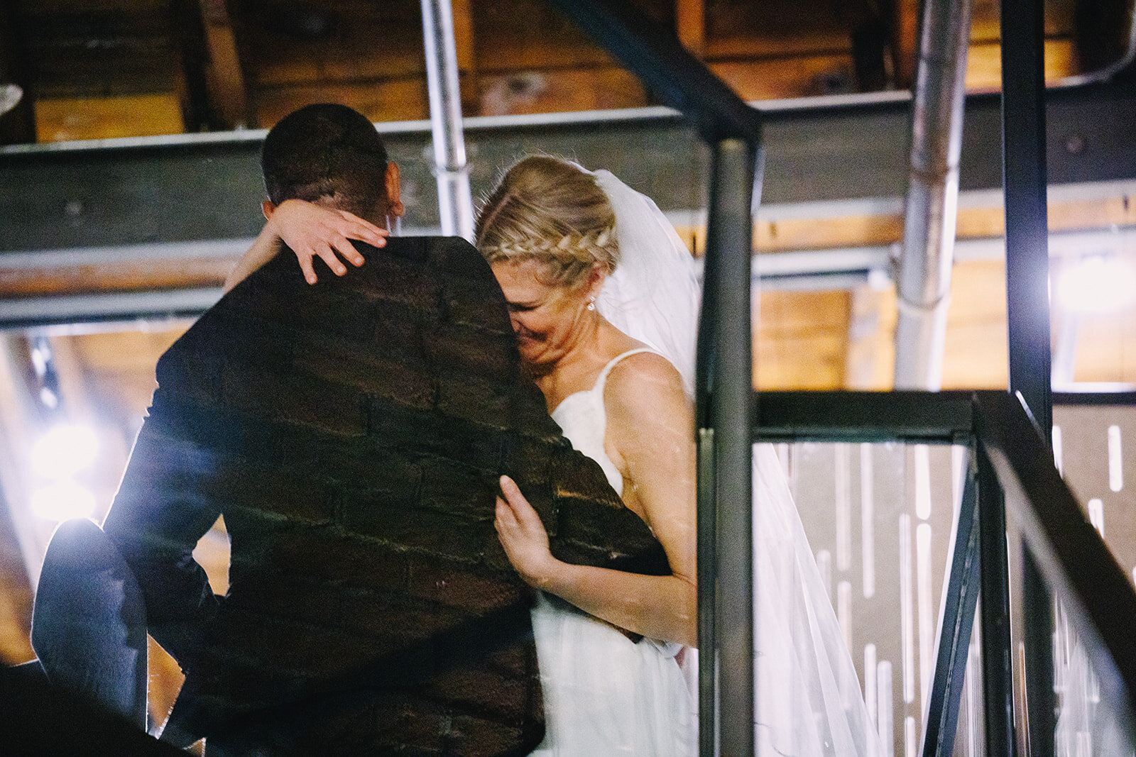 When the post-ceremony, grand entrance giggles hit 😍🖤 

Photography: @derksworks 

Image descriptions: 
Image one: A bride and groom candidly embrace at the top of the stairs of the mezzanine overlooking the main hall. 
Image two: The same bride an