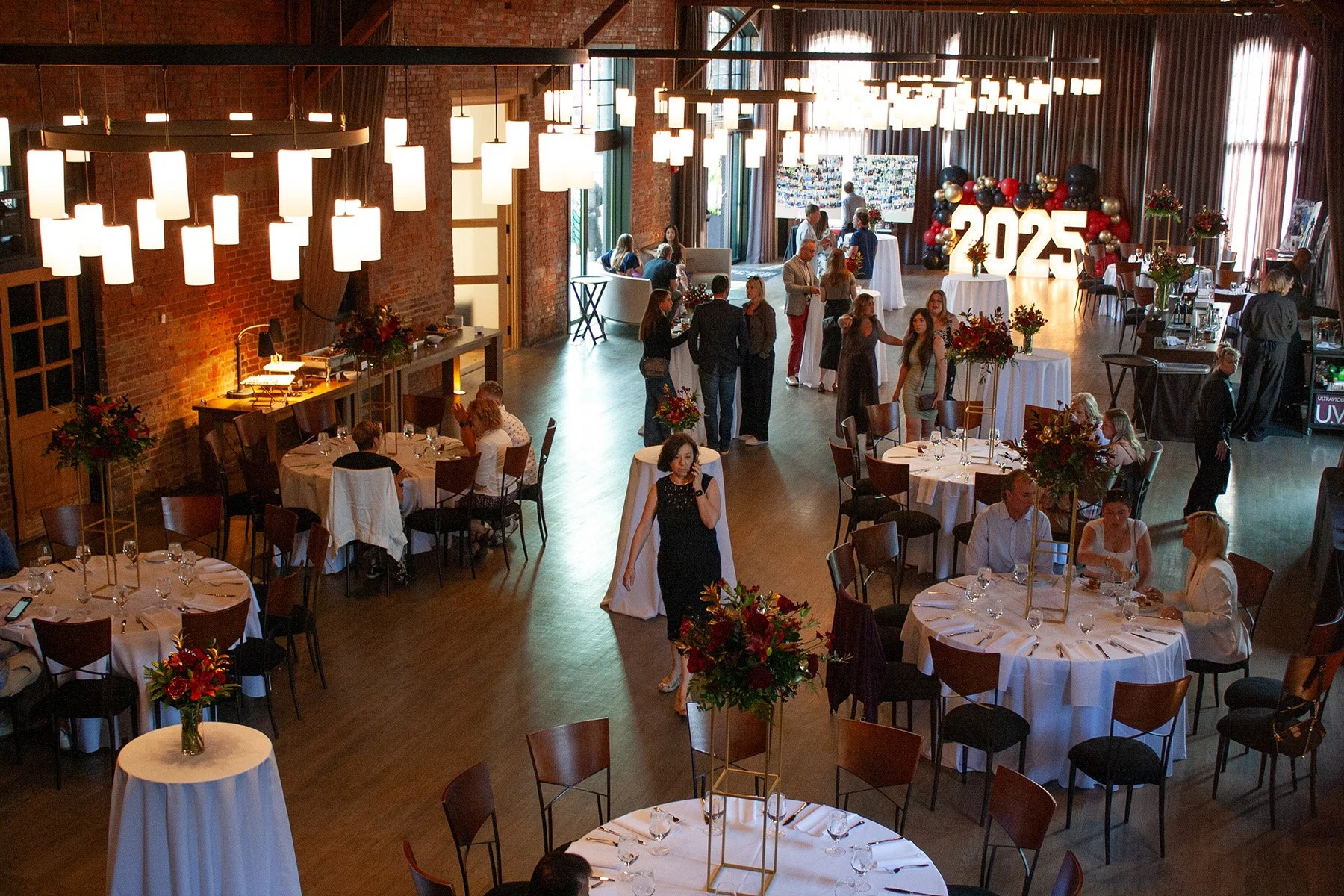 An overhead view of a graduation party at a historic industrial event venue, High Line Car House