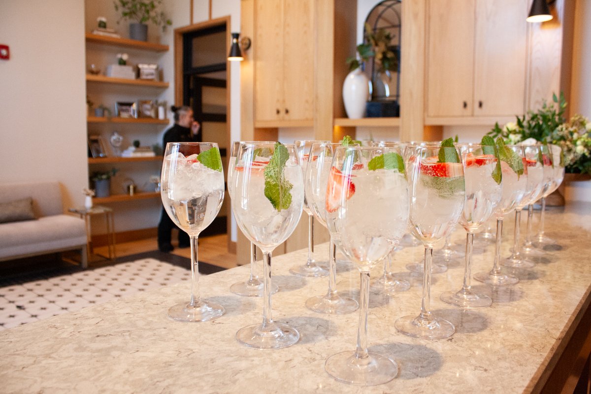 Custom welcome cocktails for a business luncheon are displayed on the bar in the foyer of High Line Car House.