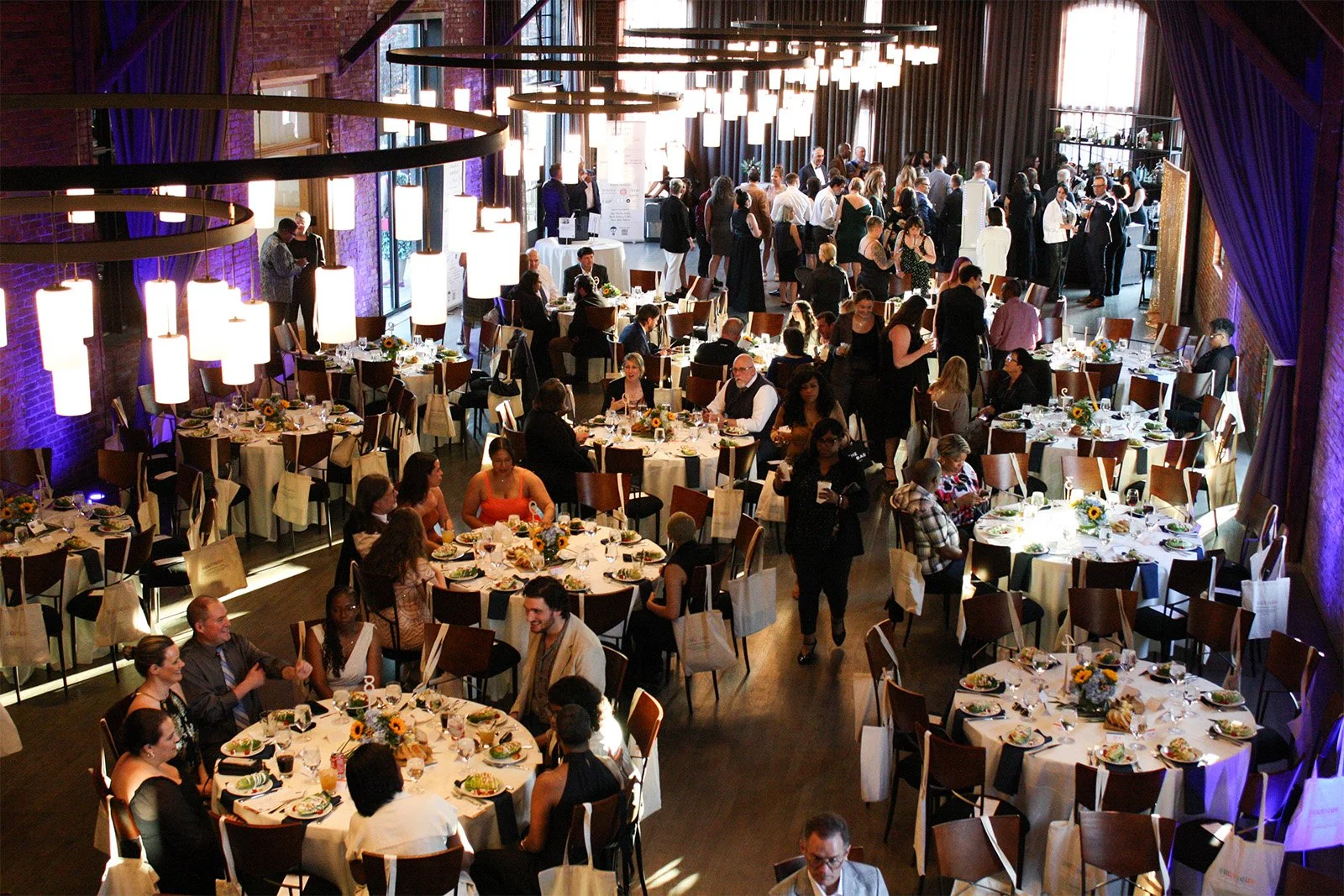 Above view of a large event space in German Village, Columbus, Ohio filled with round tables for a nonprofit celebration and fundraiser.