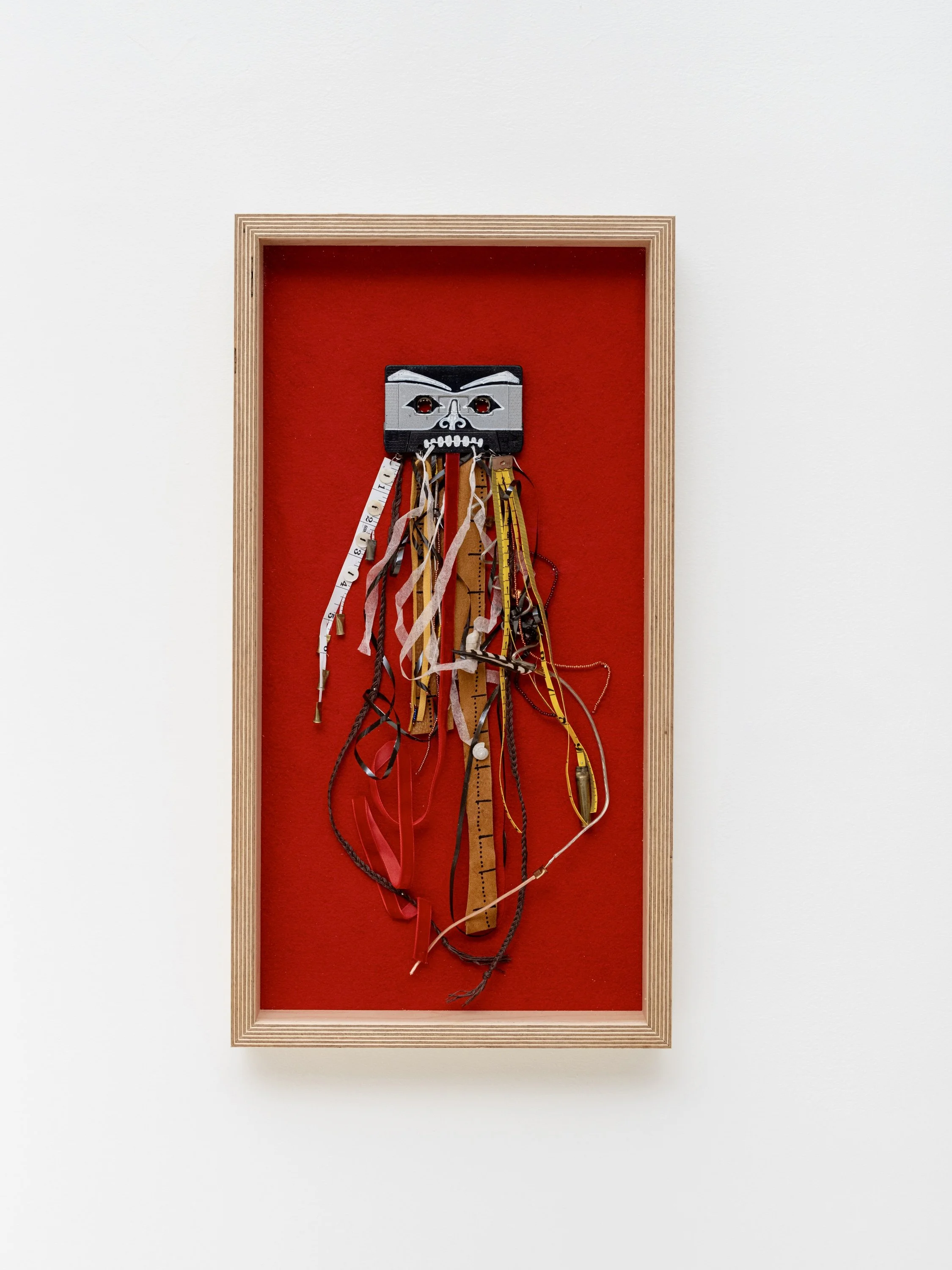 insecure mix. suspense story. i never mistook myself for someone who measured up, 2025
cassette tape, measuring tape, paint, deer leather, velvet ribbon, .22 brass, .223 brass, mother of pearl buttons, glass beads, mulberry paper, cord, sea glass, sn