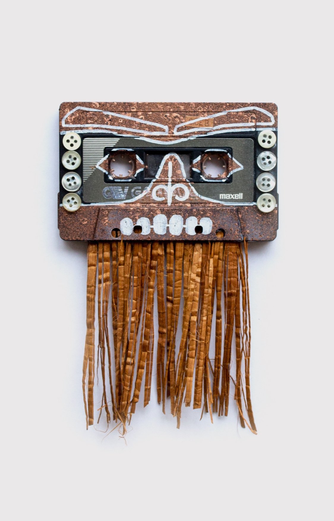 Insecure Mixtape. Canoe Story. 31. Our Stories Carry Us through Time Together (Dance to Keep them Alive.) 2023. Cassette tape, spray paint, paint marker, antique mother of pearl buttons, cedar bark. 