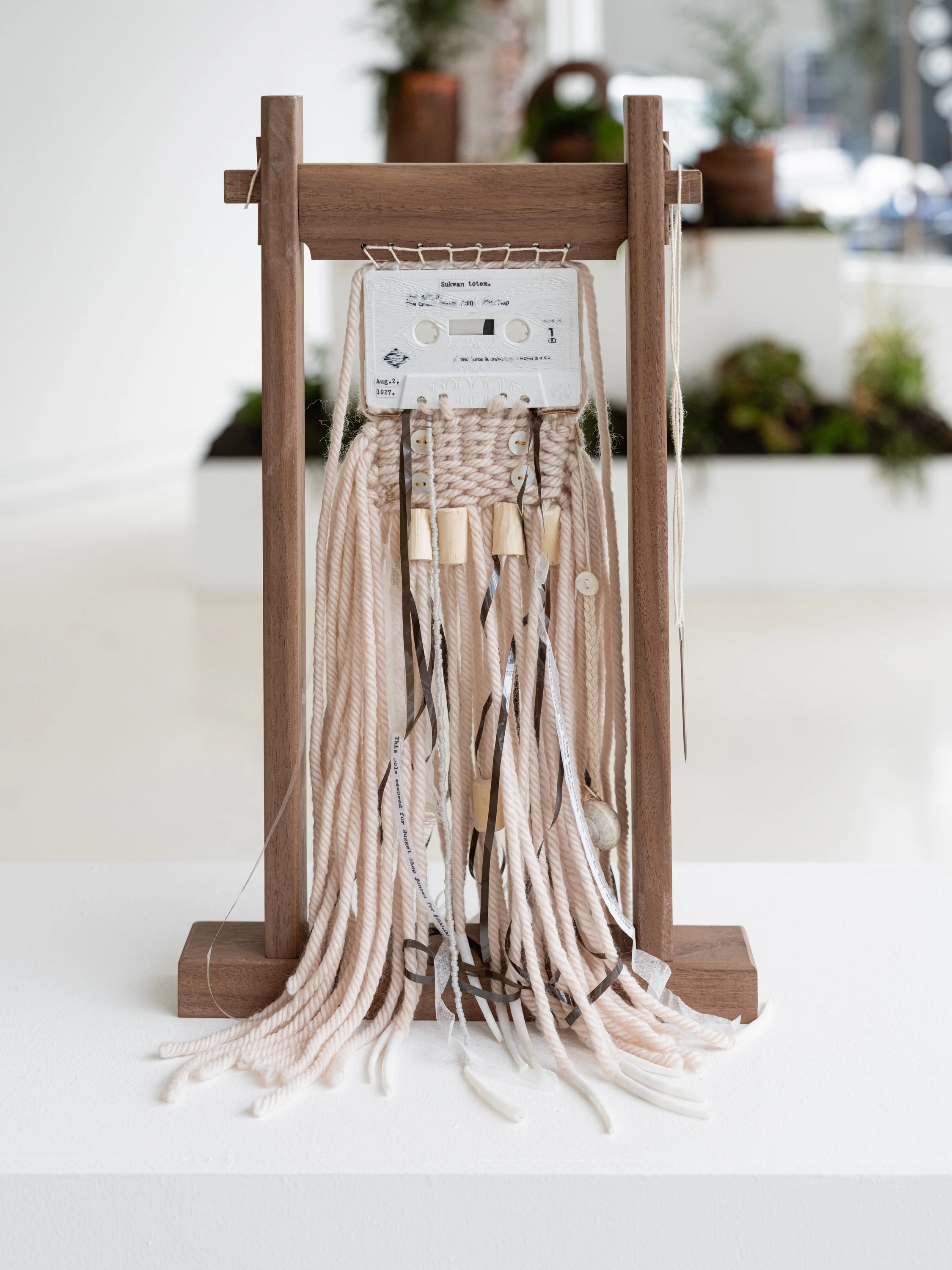 Insecure mix. Persistence story. gahl hal káaygaagang / she was born with it. (Within an Inch of Your White), 2025
etched cassette tape, walnut loom, woven merino wool yarn, devil’s club, dentallium shells, mother of pearl buttons, United States Depa