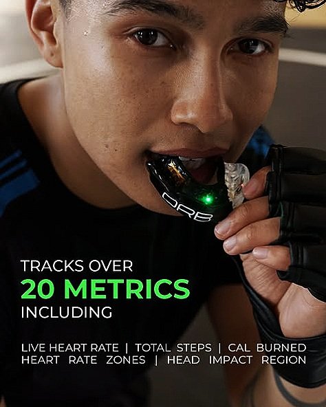 Person biting a digital mouthguard orb sport smart mouthguard for tracking fitness metrics, including heart rate and calorie burn.