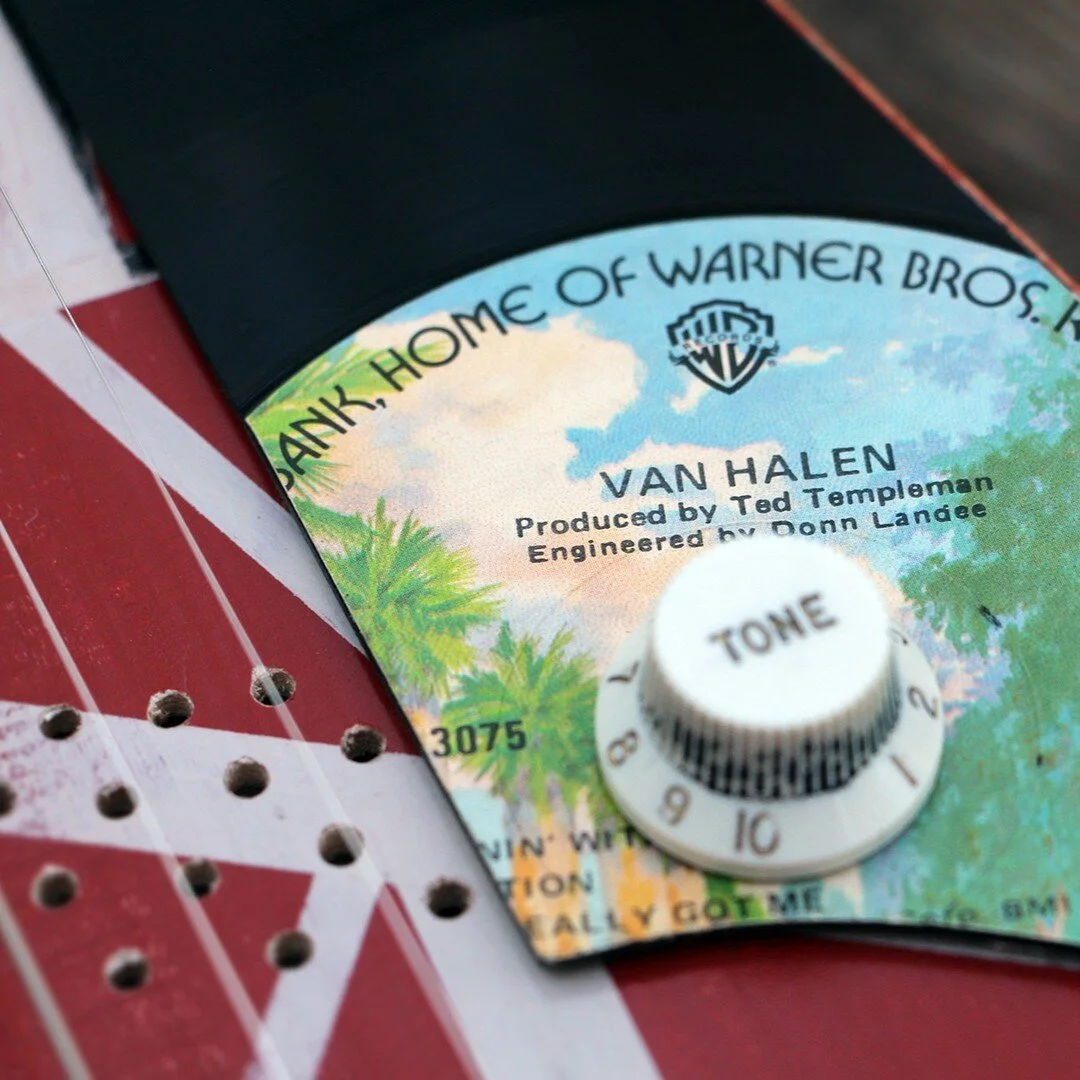 Inspiration for this guitar came from Eddie VanHalen&rsquo;s iconic Frankenstrat guitar. It is an acoustic three string piece with a piezo pickup, begging to be plugged in. Woods in this guitar include walnut, bloodwood, birdseye maple, and hard rock