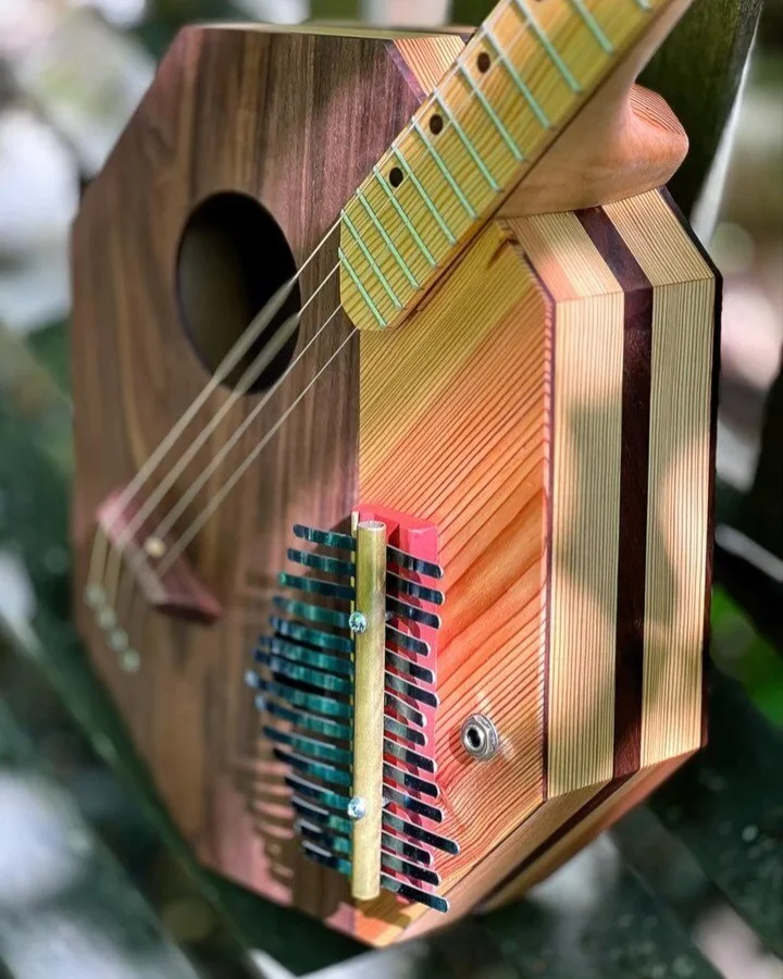 This four string, acoustic/electric guitar includes a built in 15 key kalimba. Materials include: walnut wood, pine wood recycled from a fifty year old stair tread, steel and brass.

Come see it at the FUSE Makers Market this Saturday, April 29, 10:0