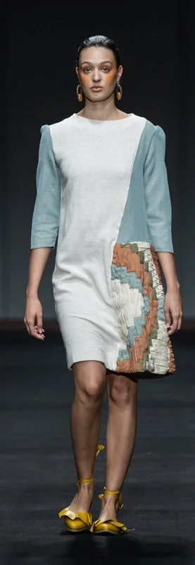 Fashion model wearing a color-block dress on the runway