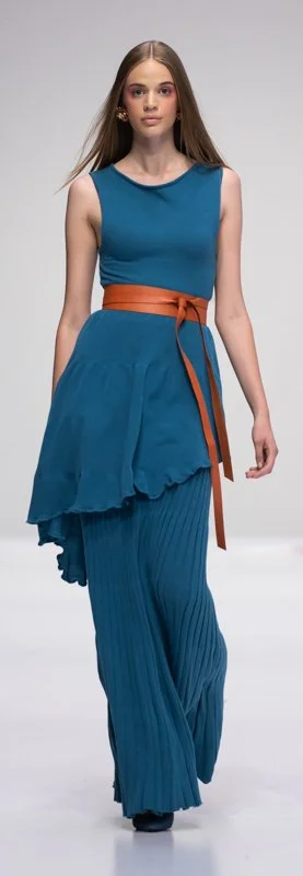 Model wearing a blue dress with pleated skirt and brown belt on runway