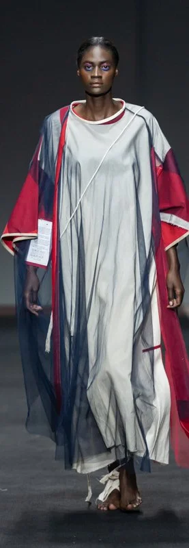 Model in layered, flowy dress on runway