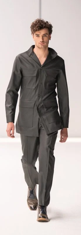 Man in a gray tailored suit walking on a runway