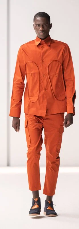 Model wearing orange outfit with jacket and pants
