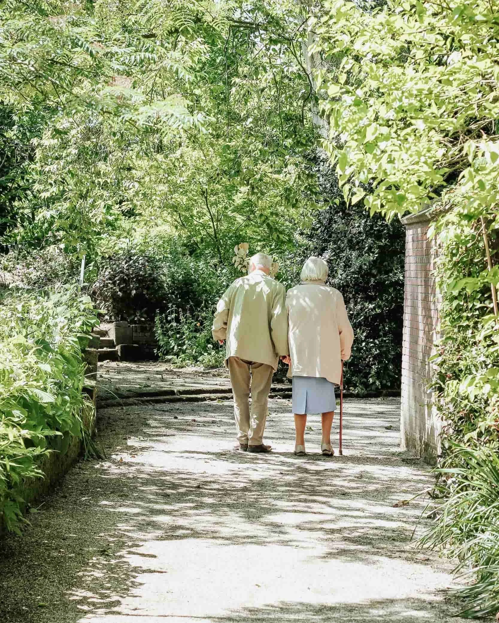 An older couple walking outdoors, representing long-term care and disability planning