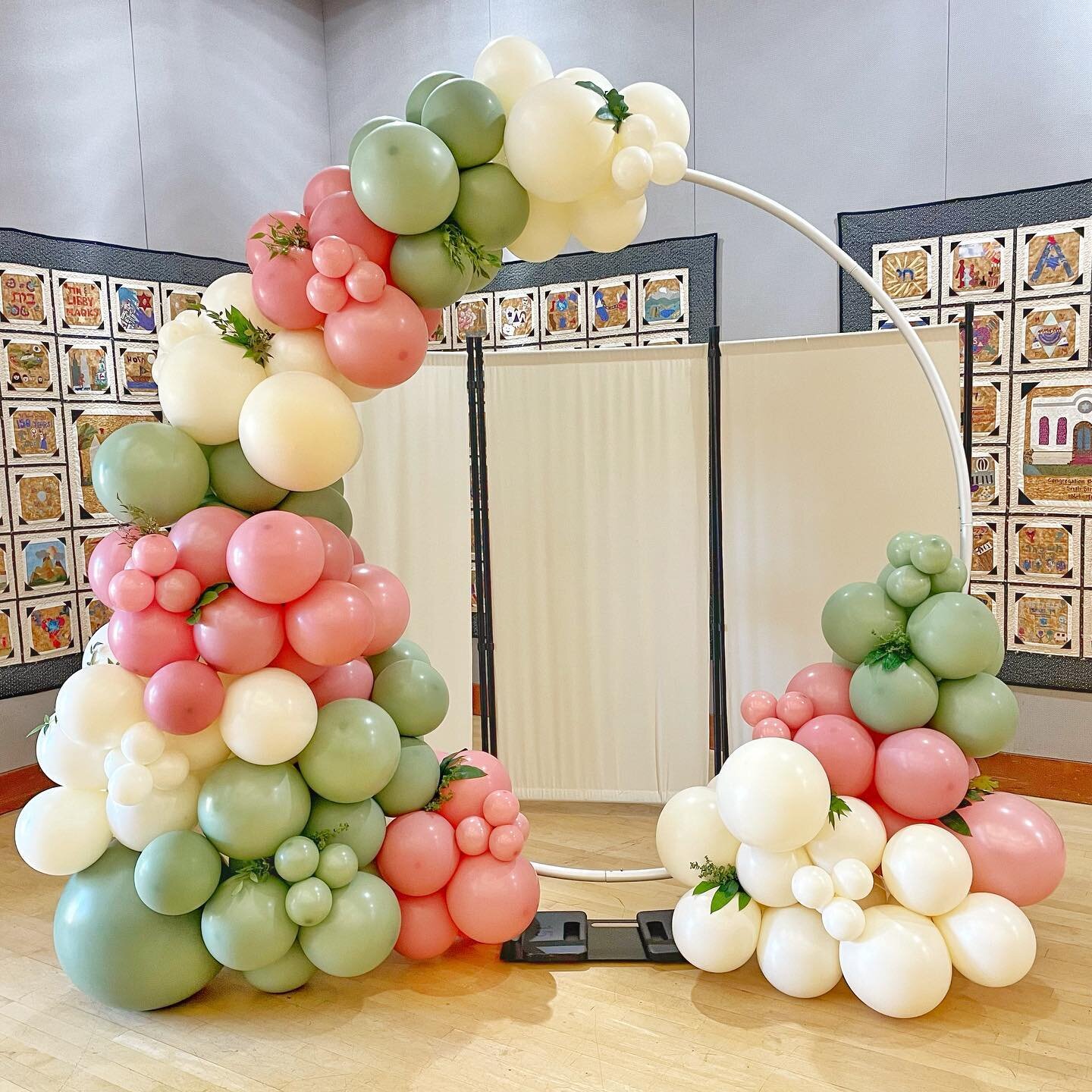 Sometimes all you need is a simple, elegant balloon hoop to make a colorful impact at your event. 

This piece filled with sage, rose, and ivory tones was a fun statement at a special Bat Mitzvah.