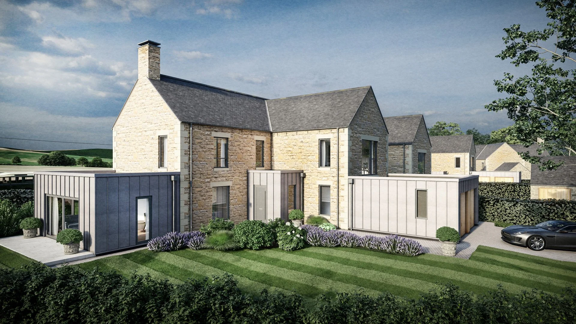 A modern residential development featuring stone houses with pitched roofs and contemporary extensions, surrounded by landscaped gardens and parked cars.