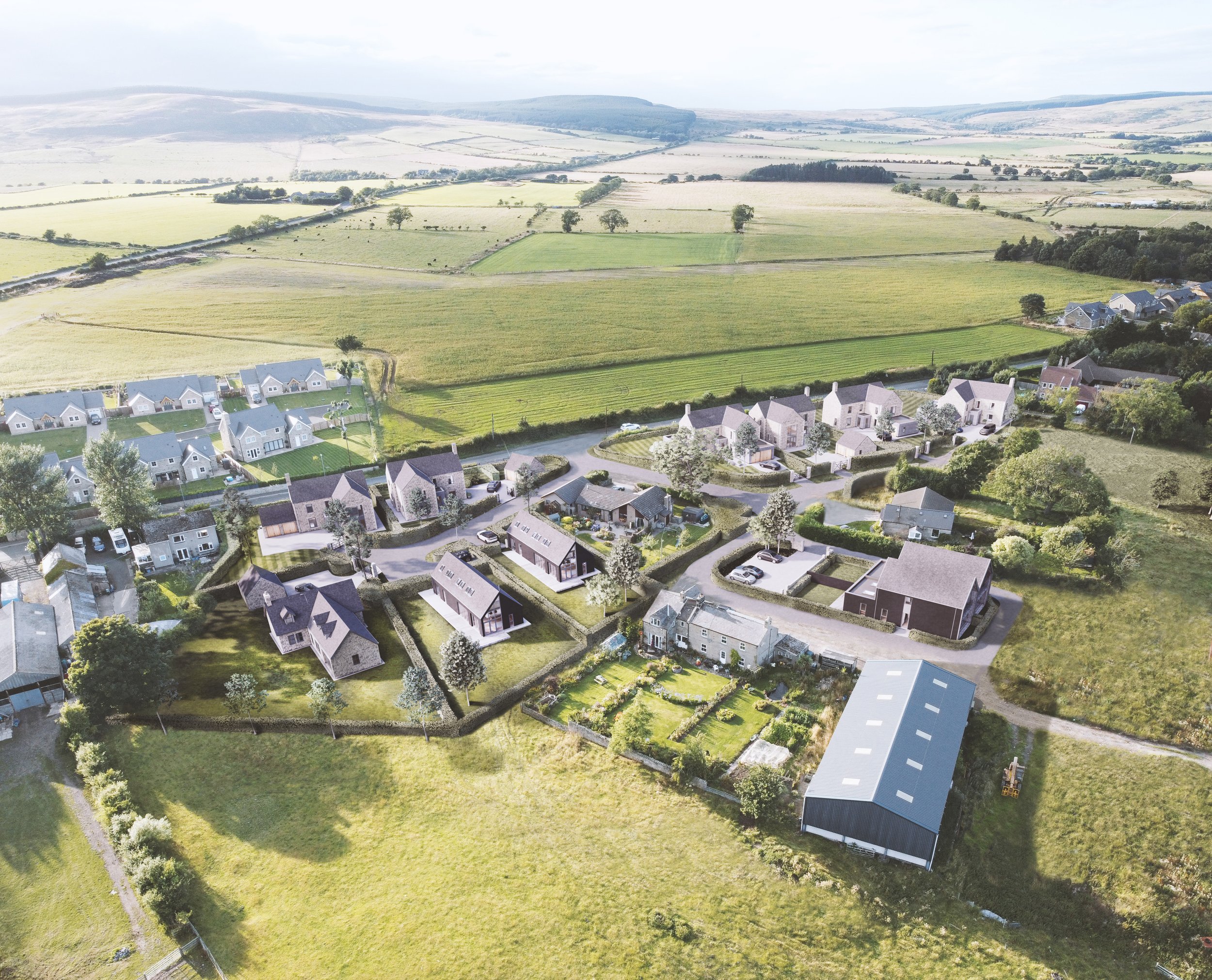 An aerial view of a residential area with houses and greenery, overlooking expansive farmland and rolling hills in the distance.