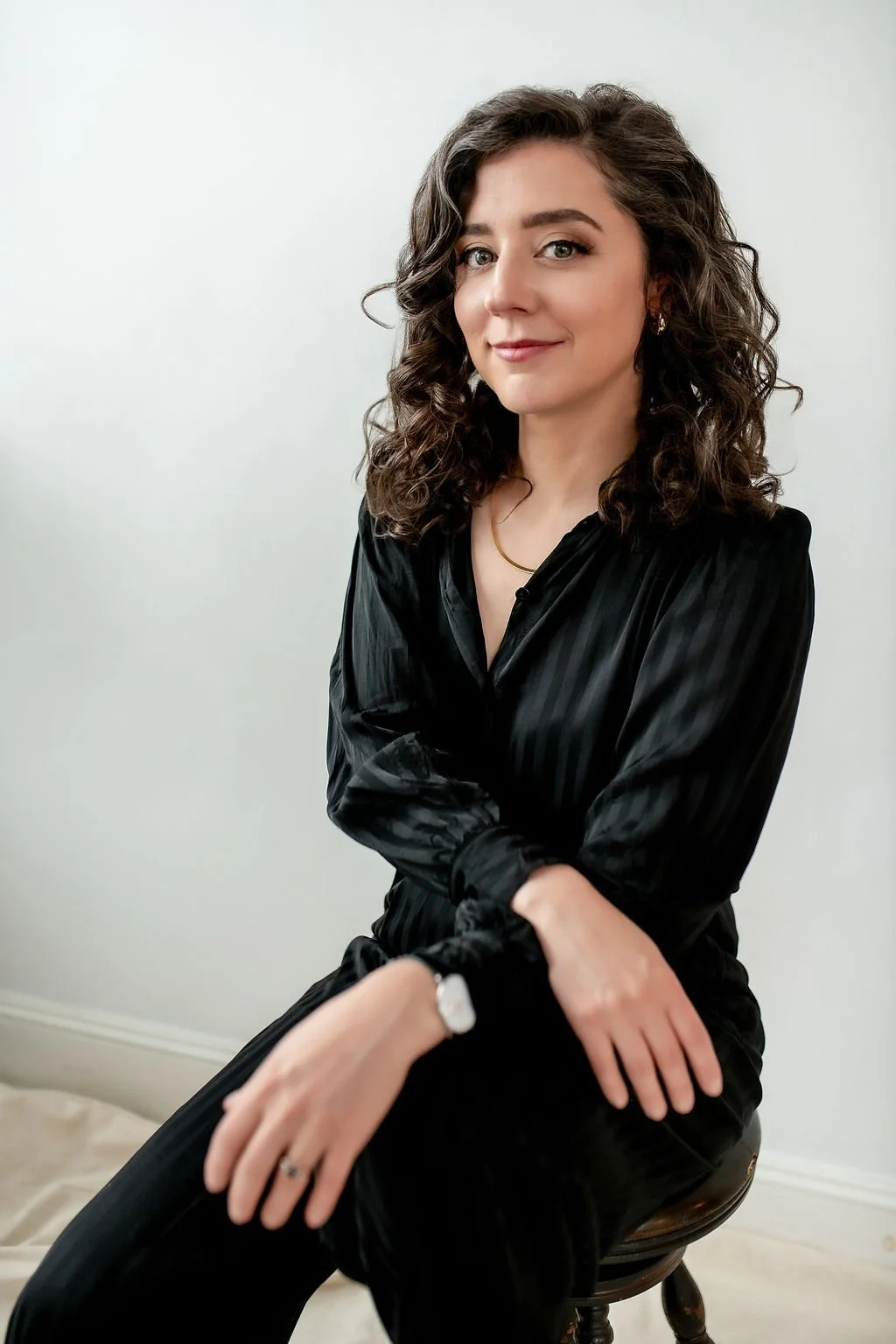 Rikki Goldenberg, career and leadership coach, smiling in a professional setting wearing a black shirt