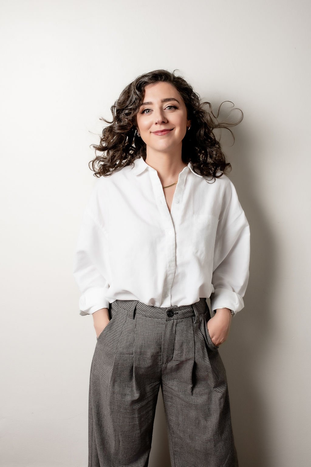 Image of Rikki Goldenberg, Career Coach, Executive Leadership Coach wearing a white button down and black and white checked pants