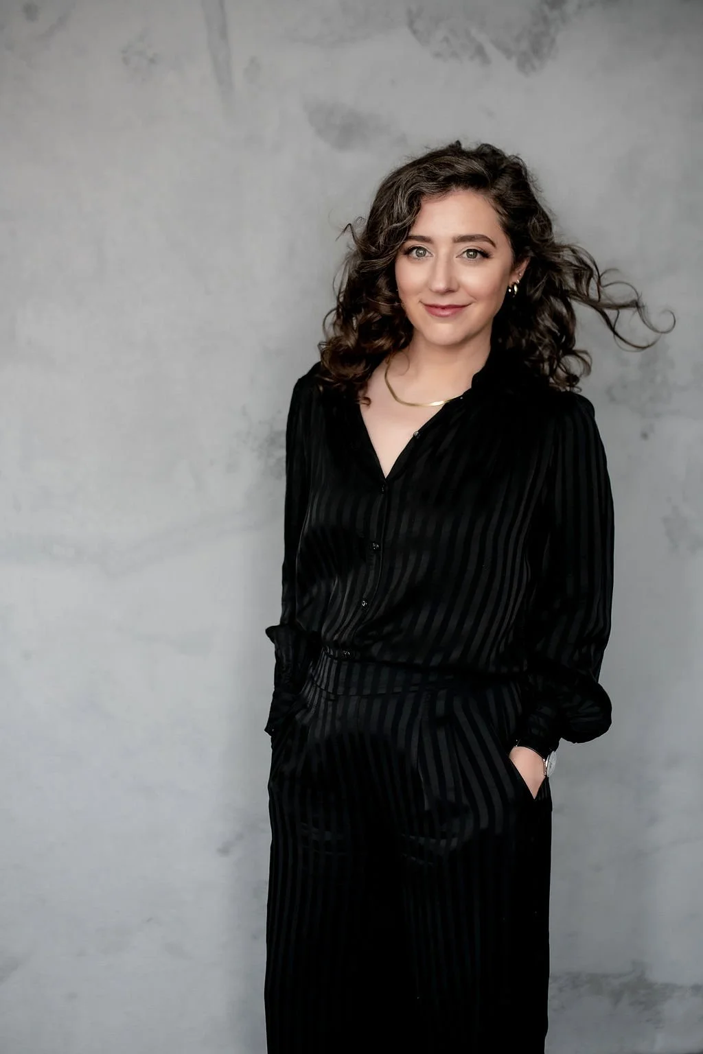 Image of Rikki Goldenberg wearing all black and smiling at the camera