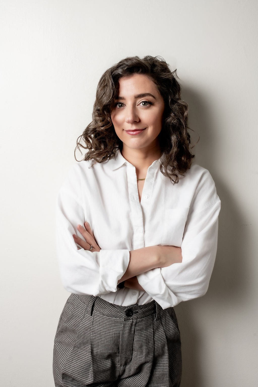 Image of Rikki Goldenberg, Career Coach, Executive Leadership Coach, wearing white button down and black and white slacks