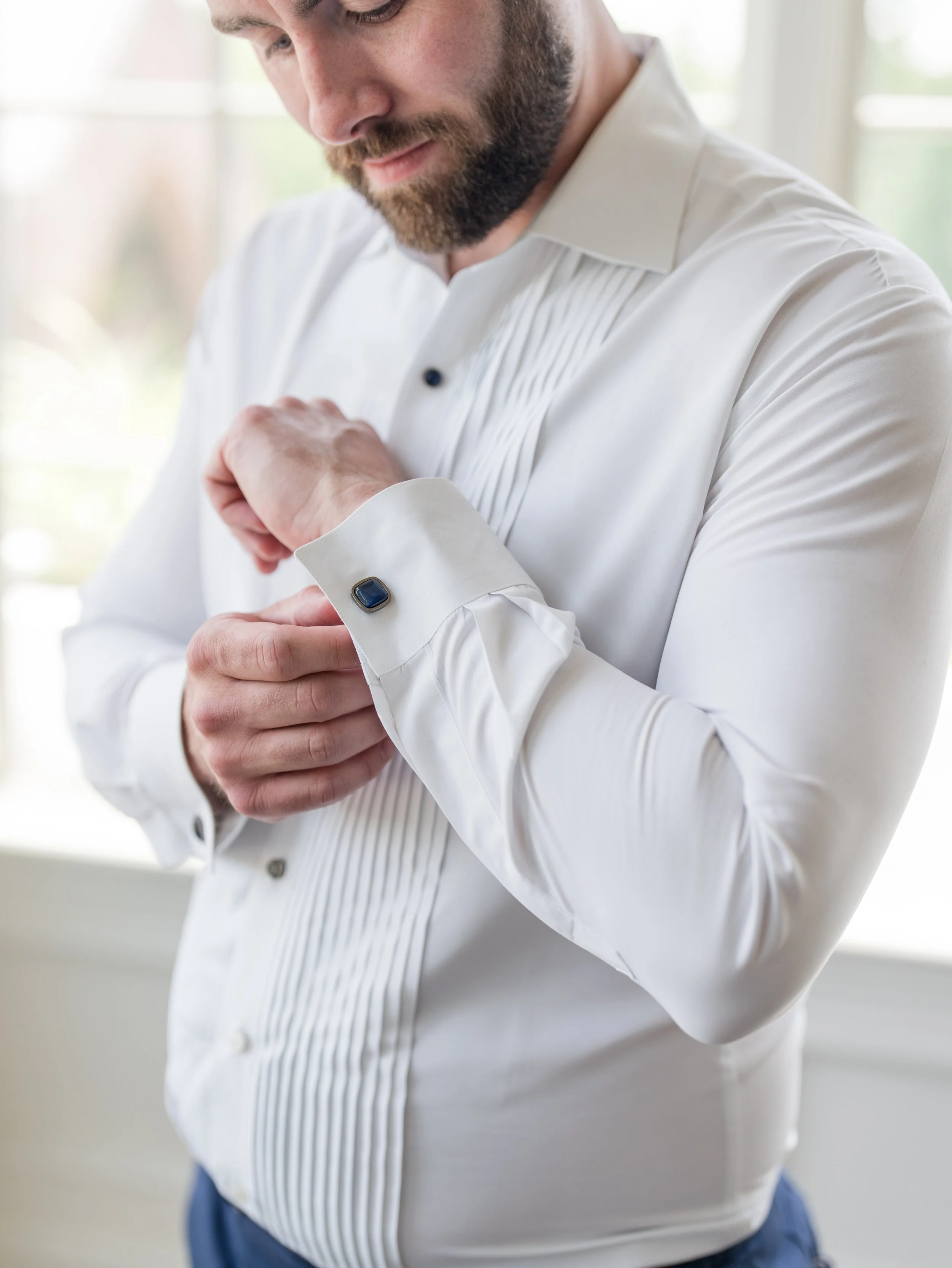 Groom fastening cuff link. Closeup solo shot getting ready by New Jersey wedding photographer, Jessica Anne Photography