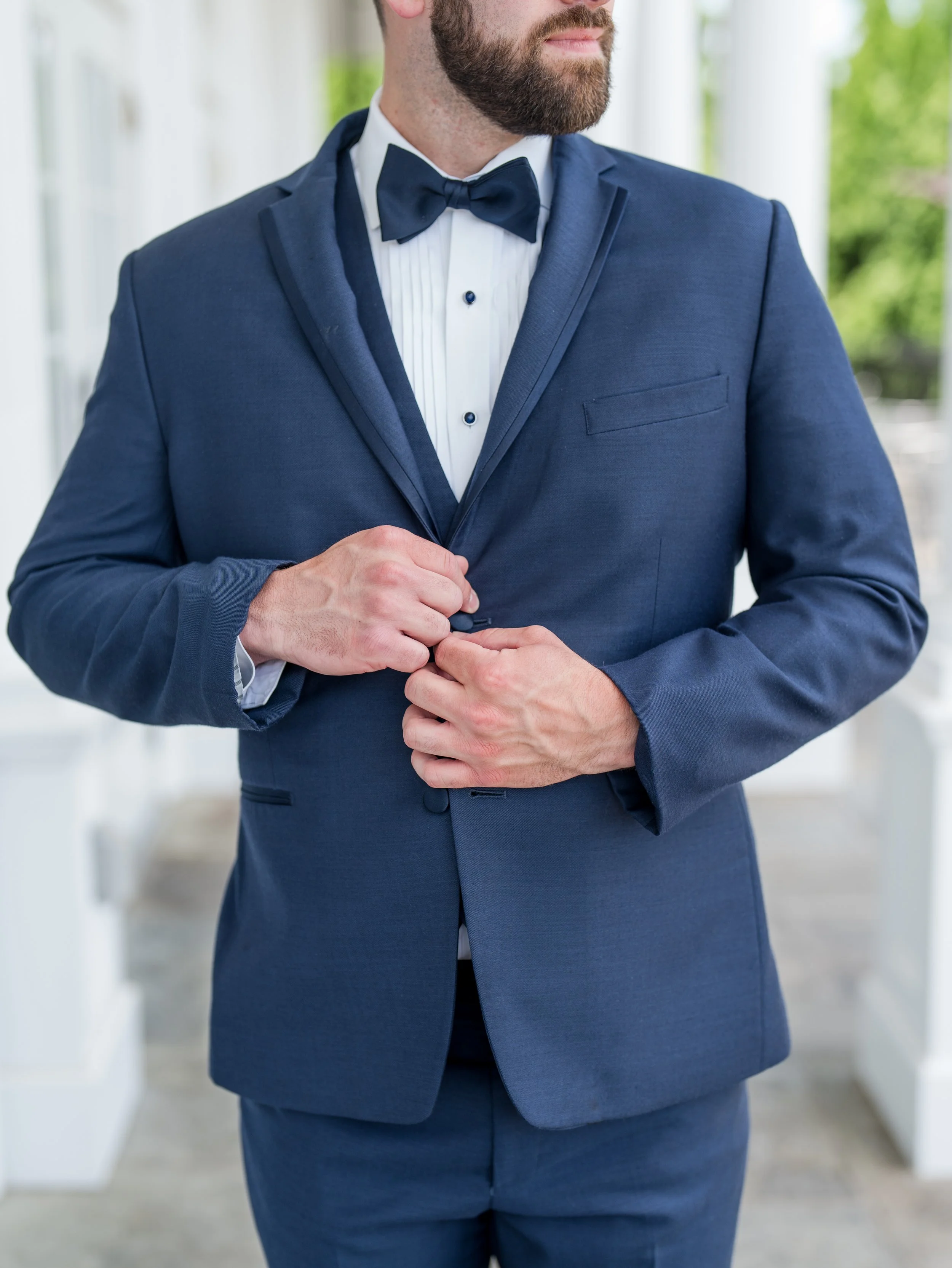 Groom close up photo buttoning jacket at The Park Savoy Estate in Florham Park, NJ by wedding photographer, Jessica Anne Photography