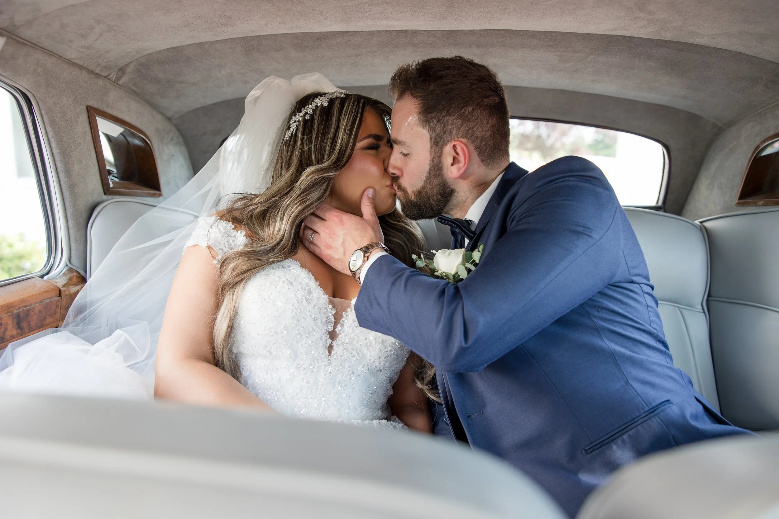 Bride and groom kissing in back seat of vintage car. Taken at The Park Savoy Estate in Florham Park, NJ by Jessica Anne Photography