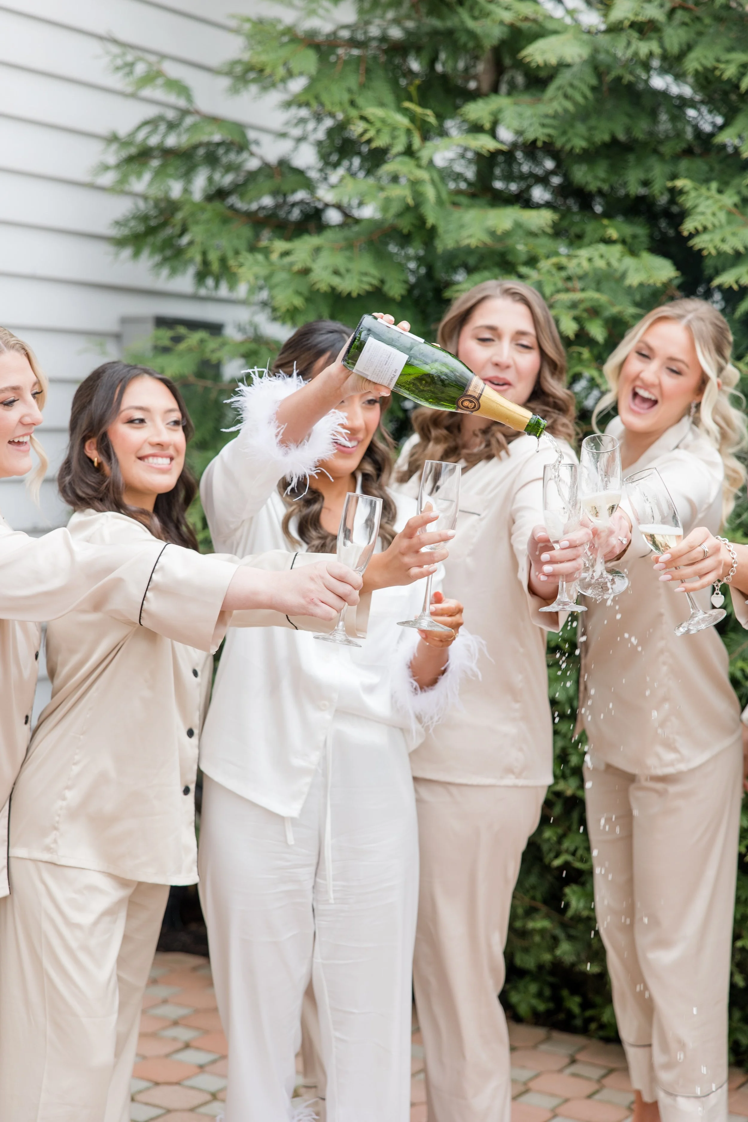 Bridal party in pajamas Champagne cheers wedding getting ready photo by Jessica Anne Photography