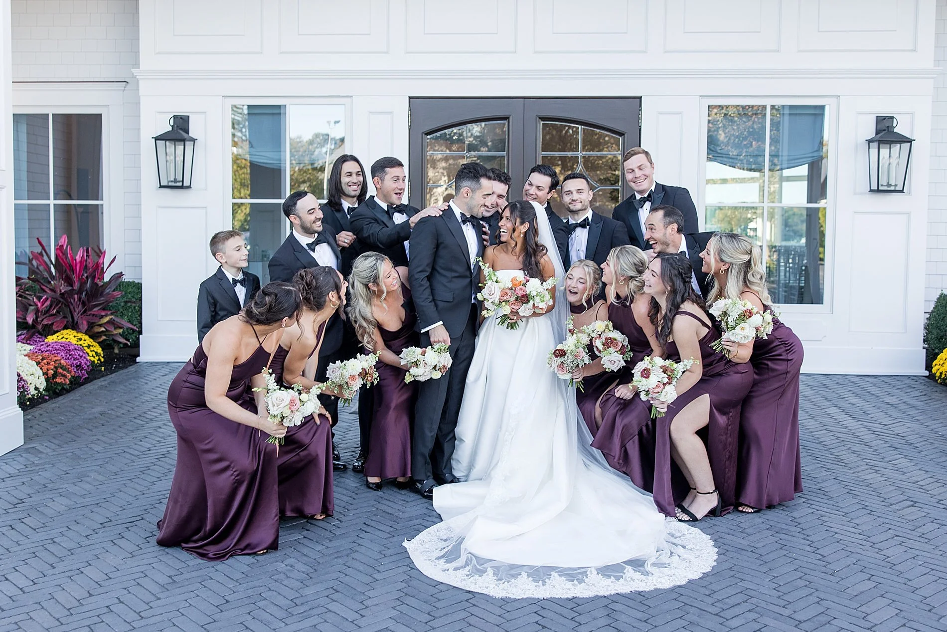  wedding party surrounds bride and groom 