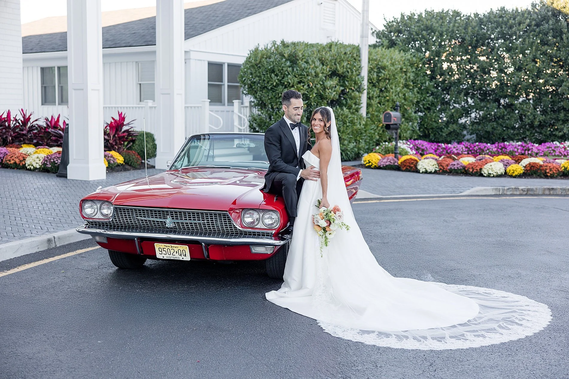 bride and groom stand by classic car at Elegant Clarks Landing Wedding   