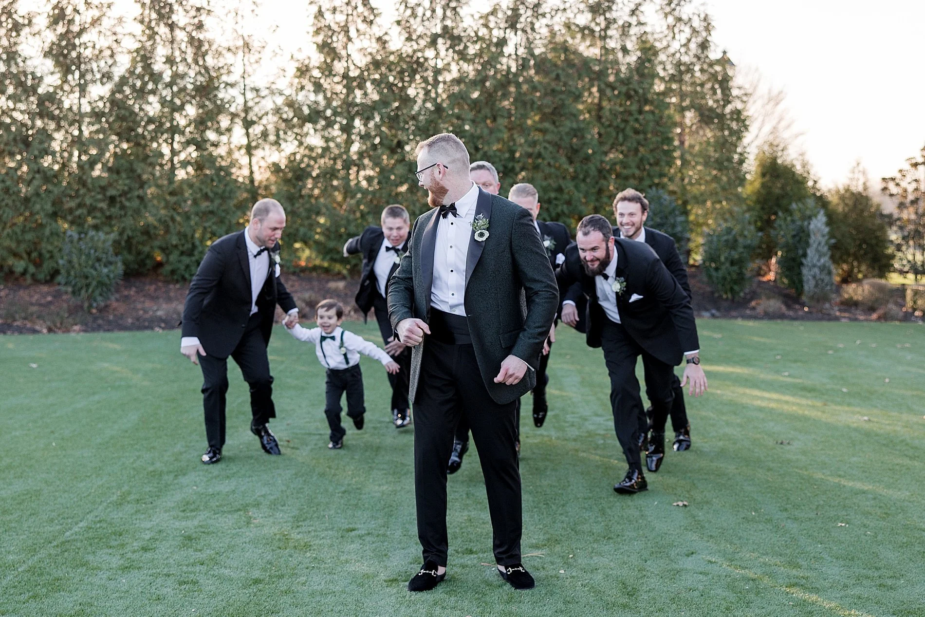  groom and groomsmen on golf course before wedding  