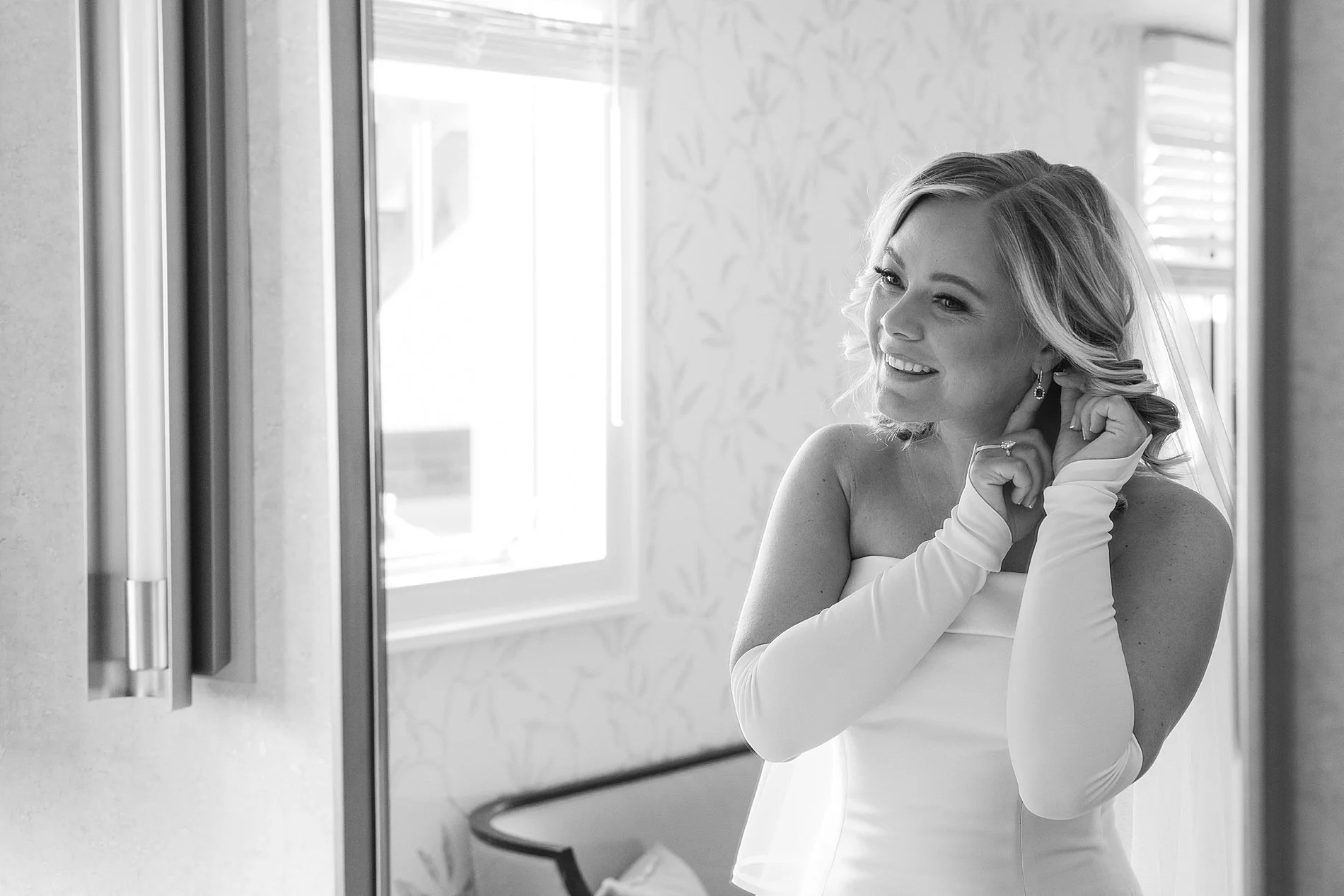  bride putting earrings in 