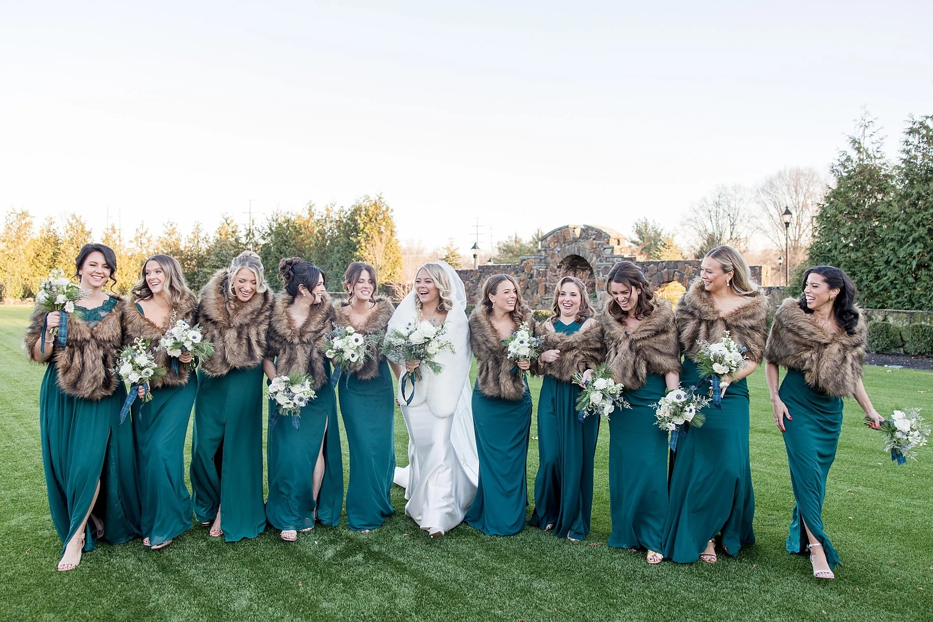  bride and bridesmaids in green dress with fur shaw from elegant winter wedding at TillingHouse 