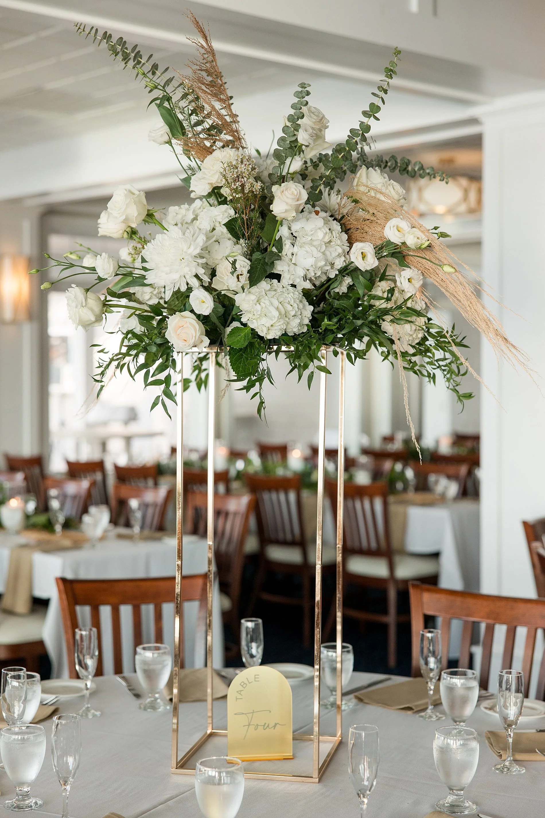  wedding flowers in tall gold vases 