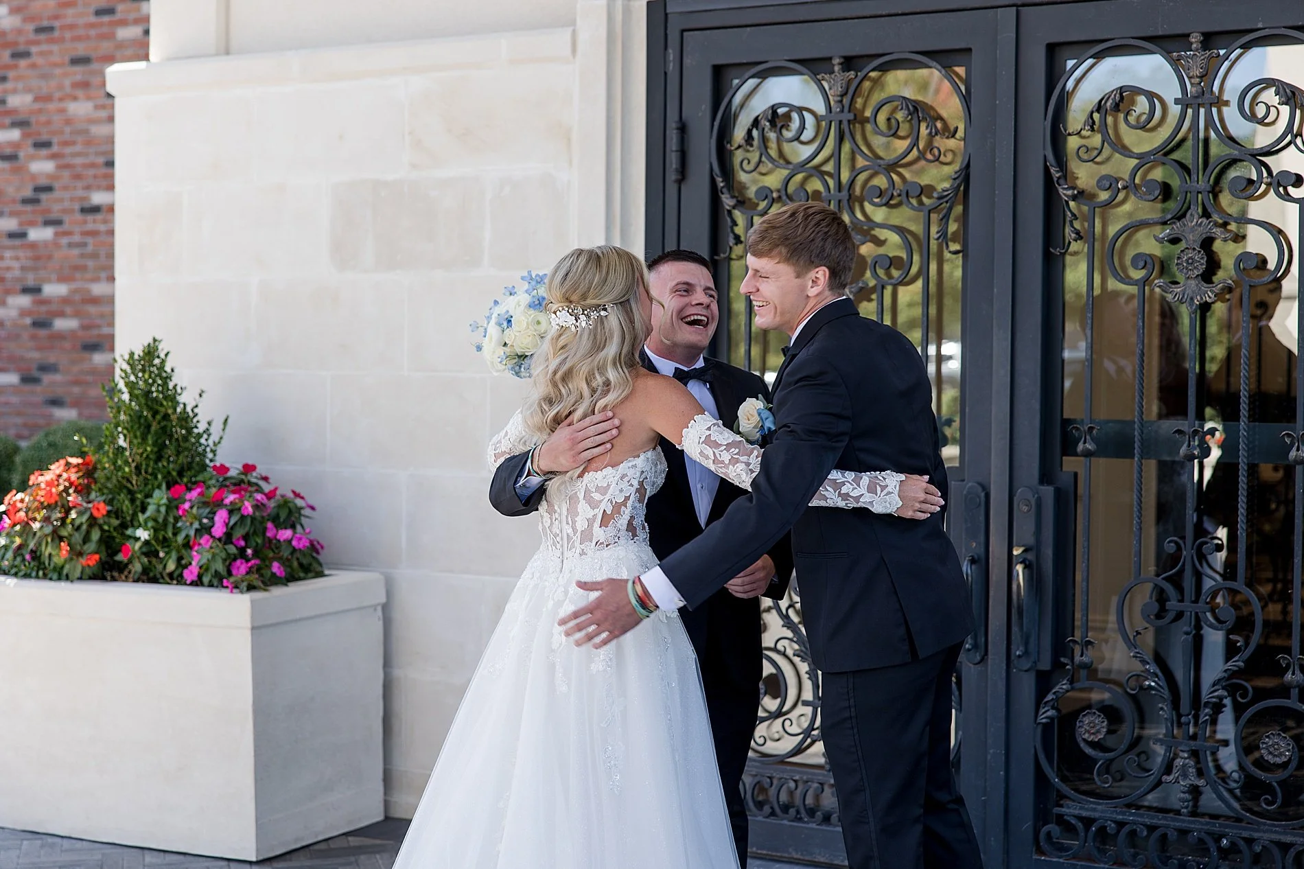  bride hugs her two brothers after first look  