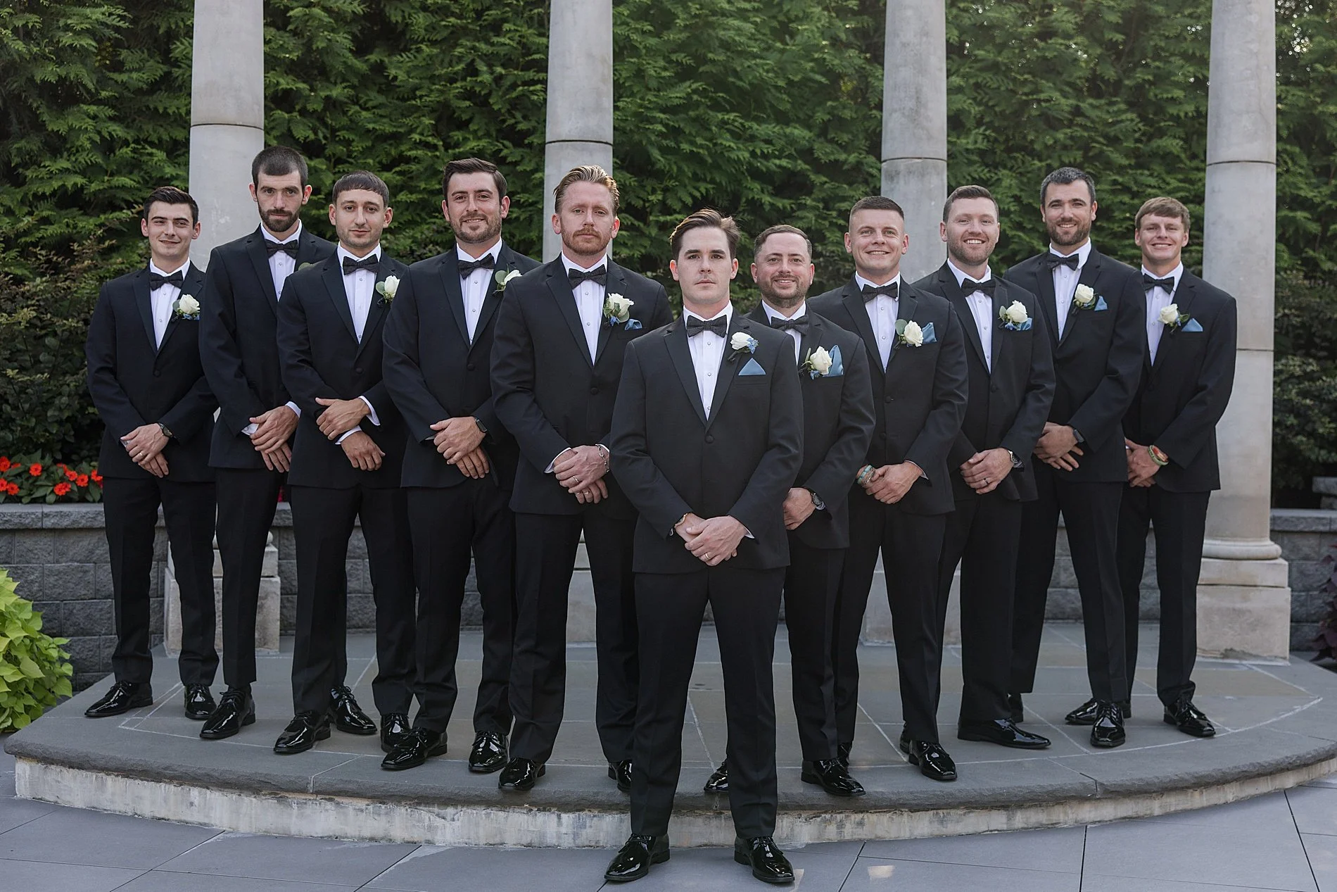  groom and groomsmen photos on the grounds of Estate of Florentine Gardens  