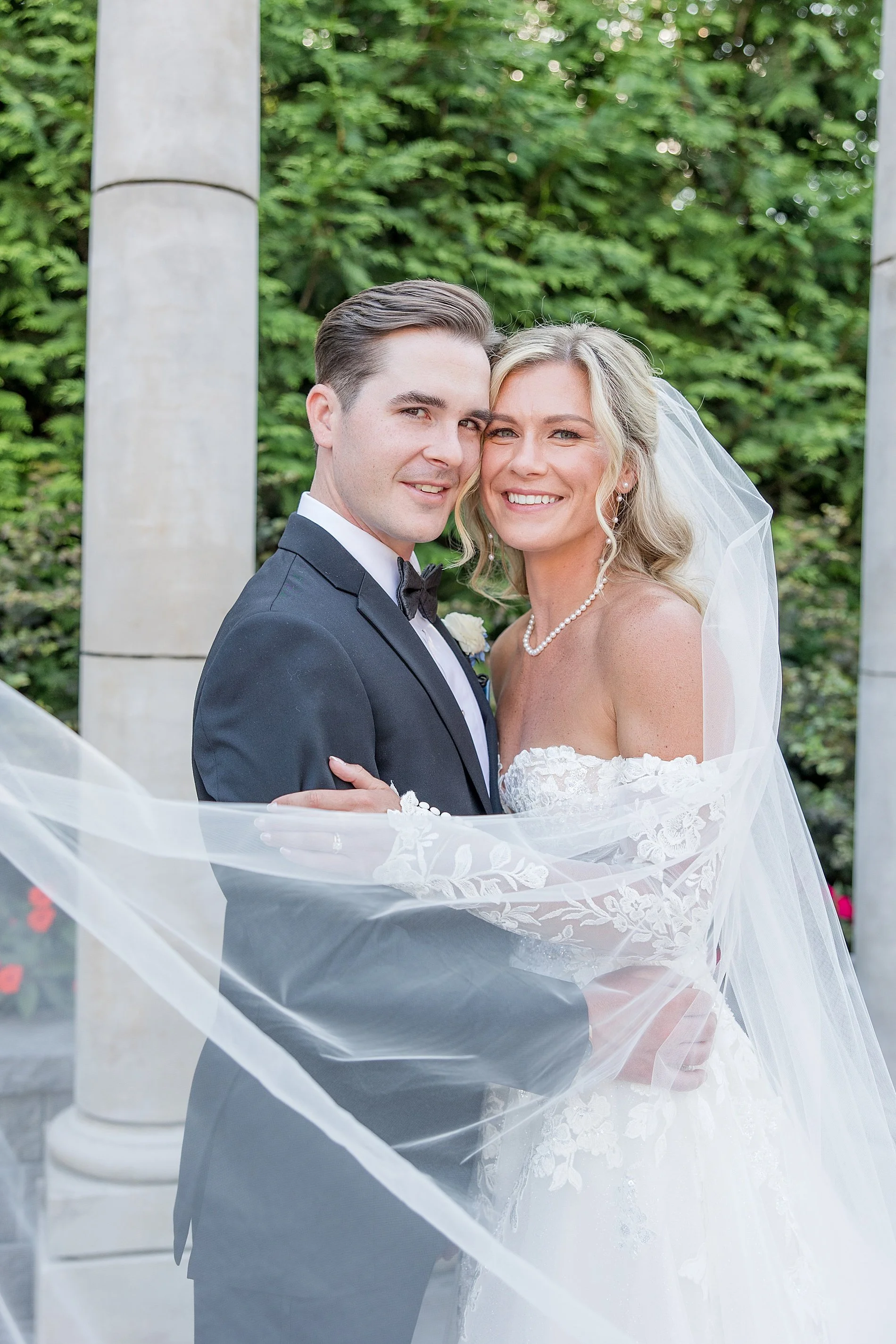  romantic wedding photos of bride and groom with veil flowing around them  